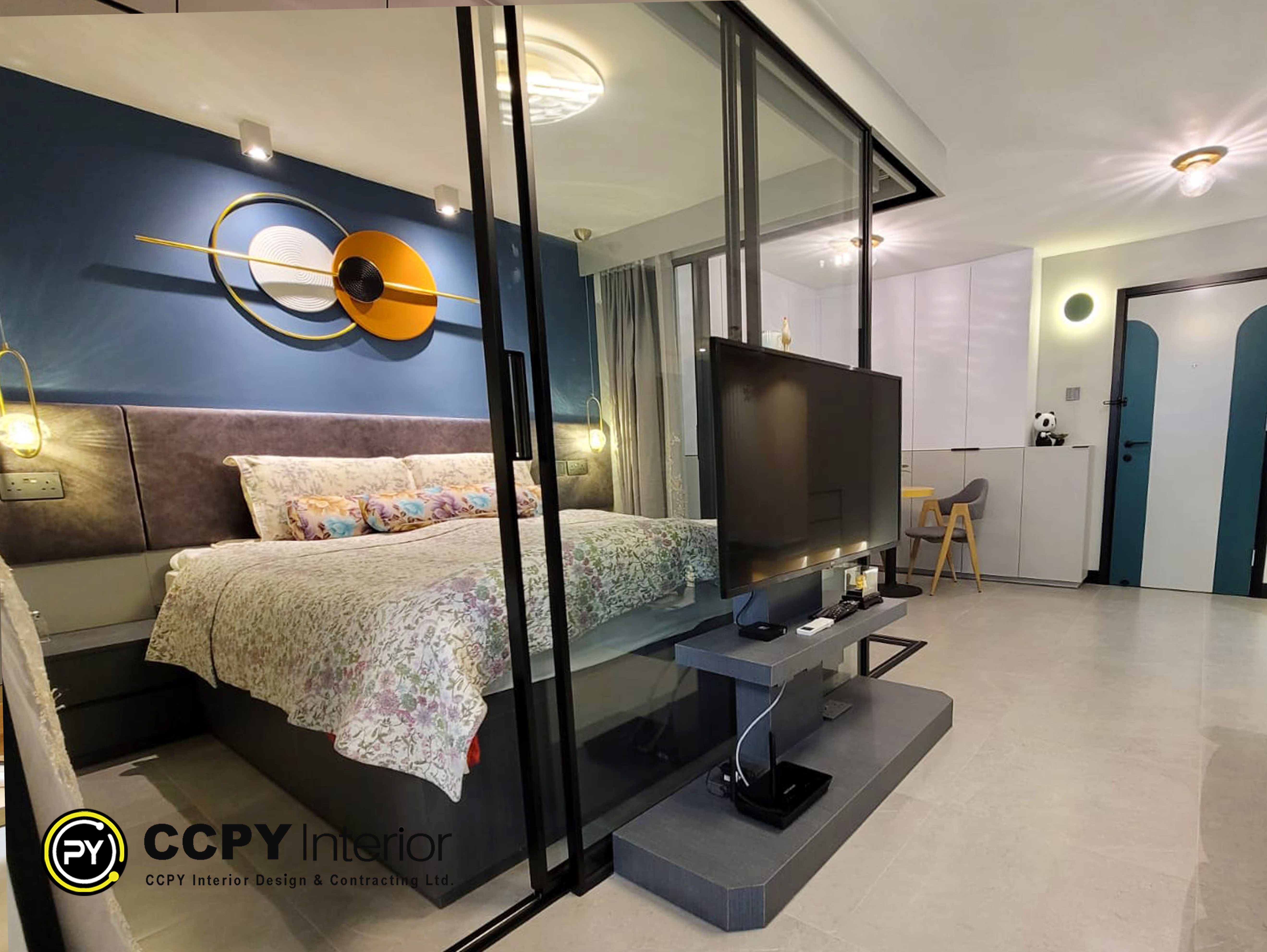 The wall is finished in a dark grey feature paint, illuminated by custom LED strips. The lower cabinet provides ample media storage, maintaining the minimalist aesthetic.