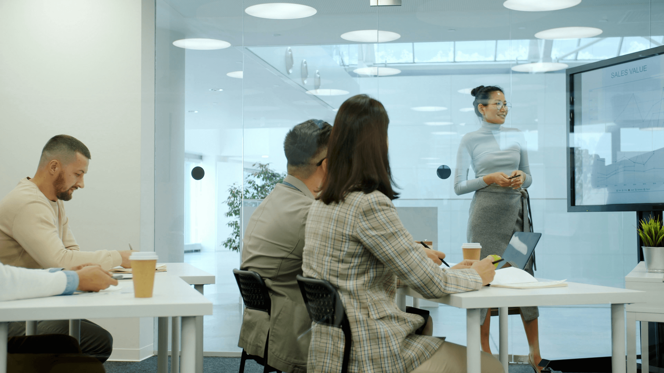 Team reviewing performance metrics as a presenter explains chart data, illustrating strategic analysis and collaborative decision-making.