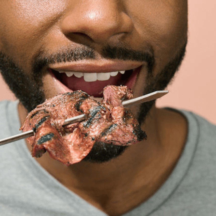 A man eating bacon.