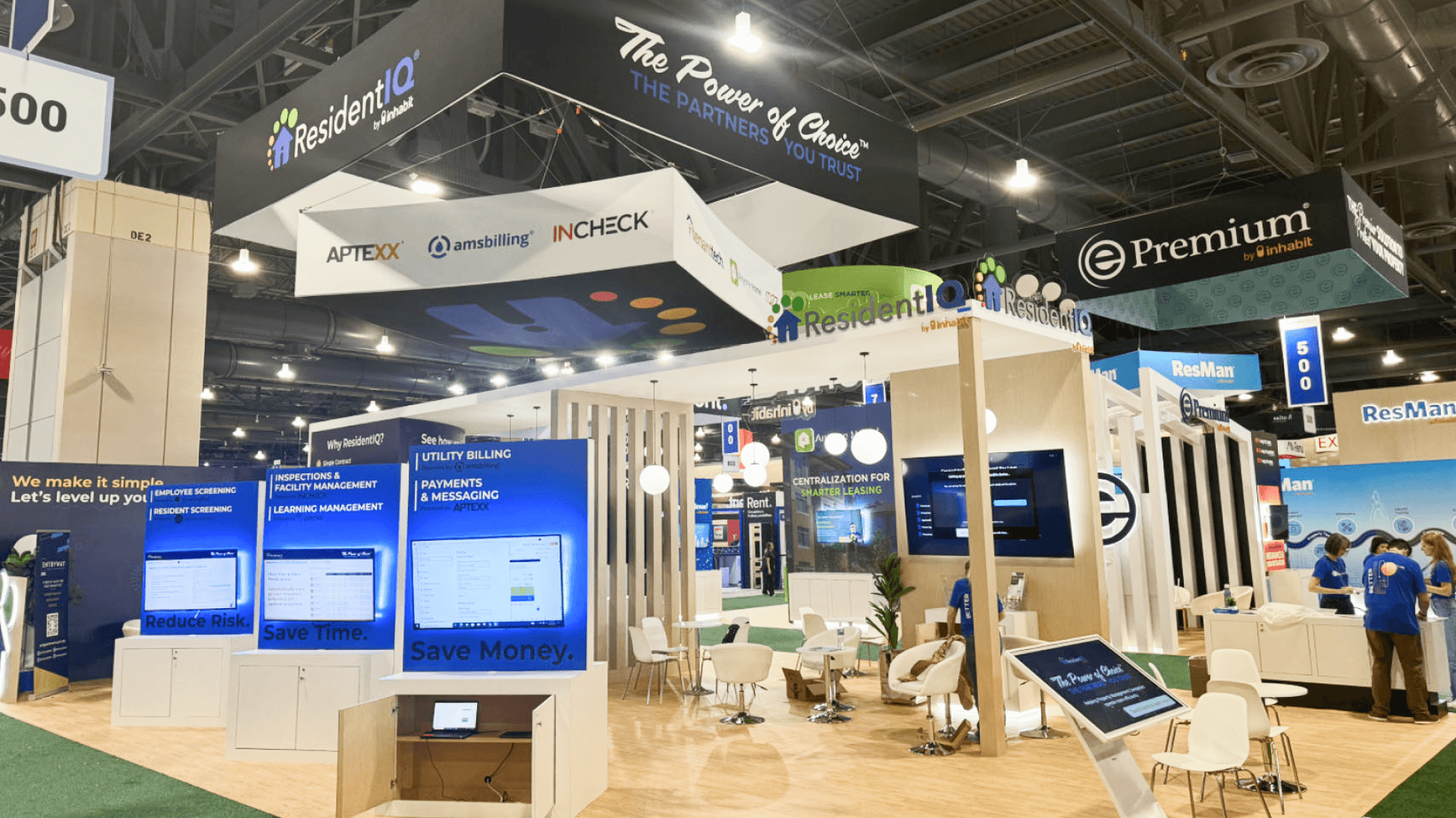 ResidentIQ Apartmentalize 2024 booth – demo wall screens and category messaging for utility billing, payments, and leasing operations in a large