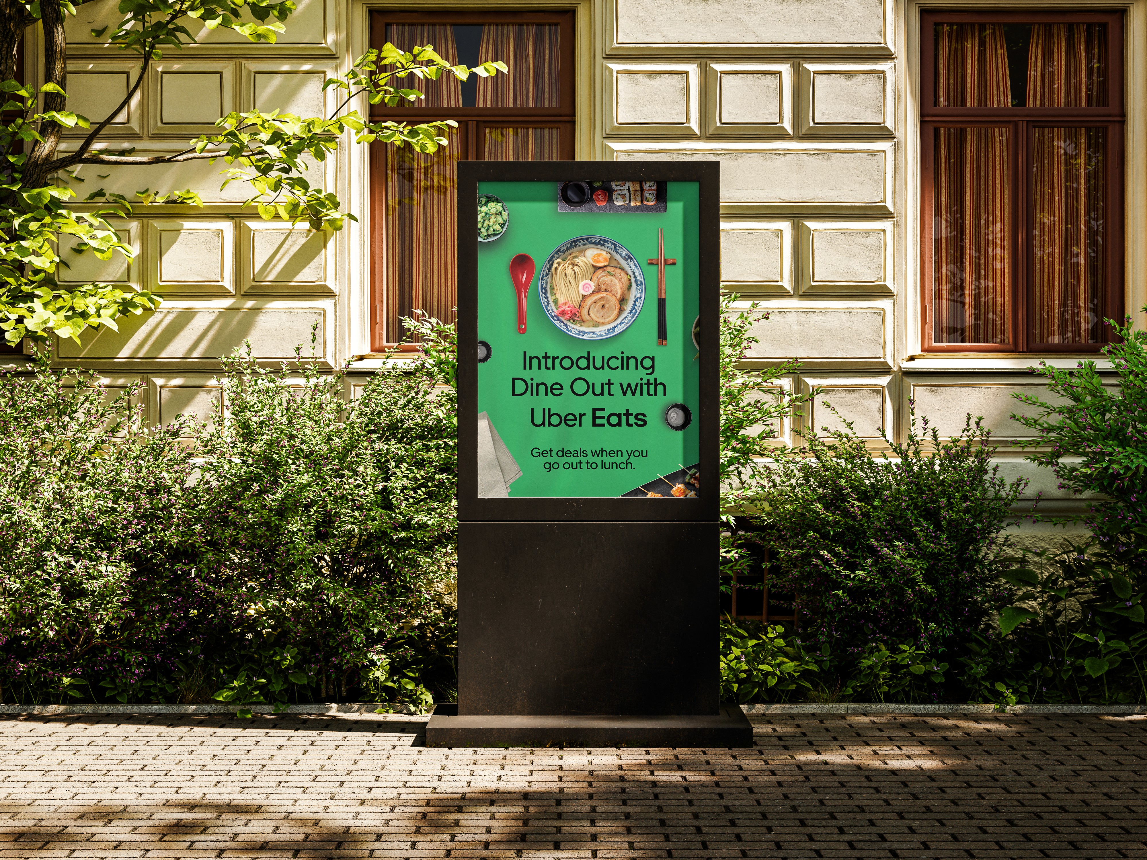 Modern home office setup with a monitor, ergonomic chair, keyboard, and indoor plants near a window with blinds.