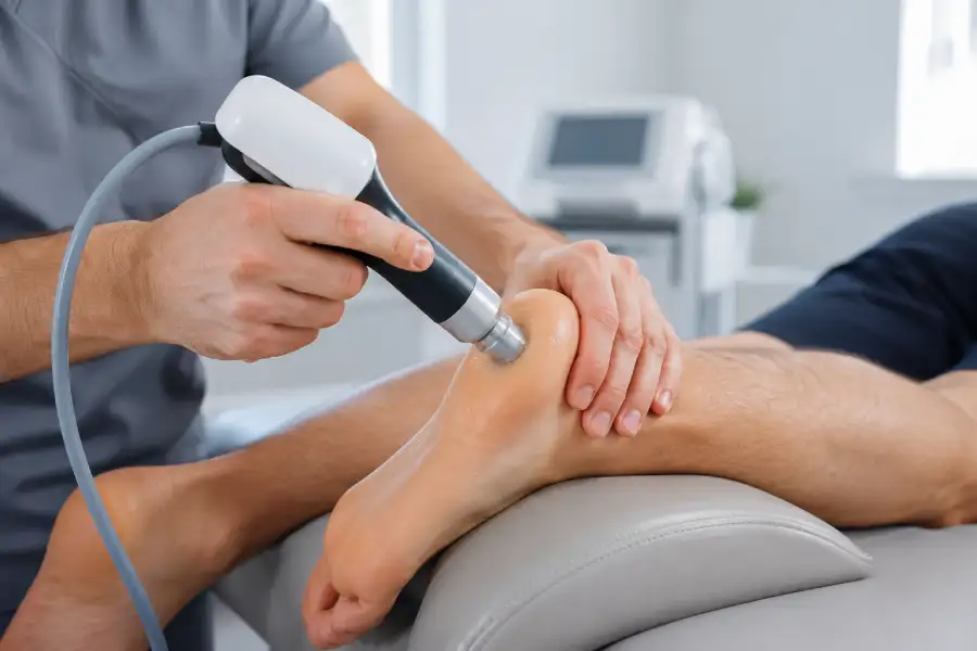 Close-up of Softwave therapy being applied to the heel for plantar fasciitis treatment.