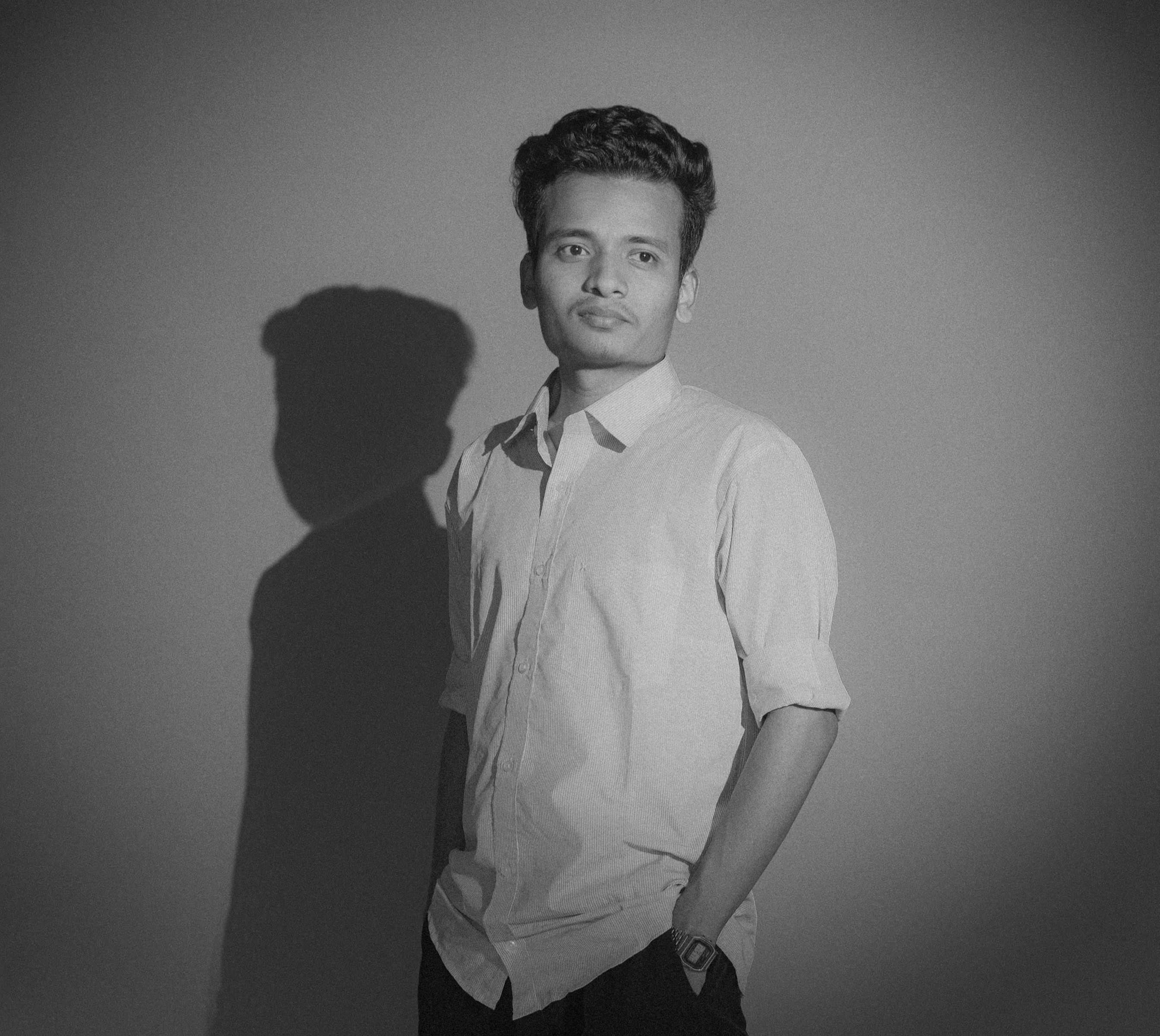 silhouette of man standing in dark room