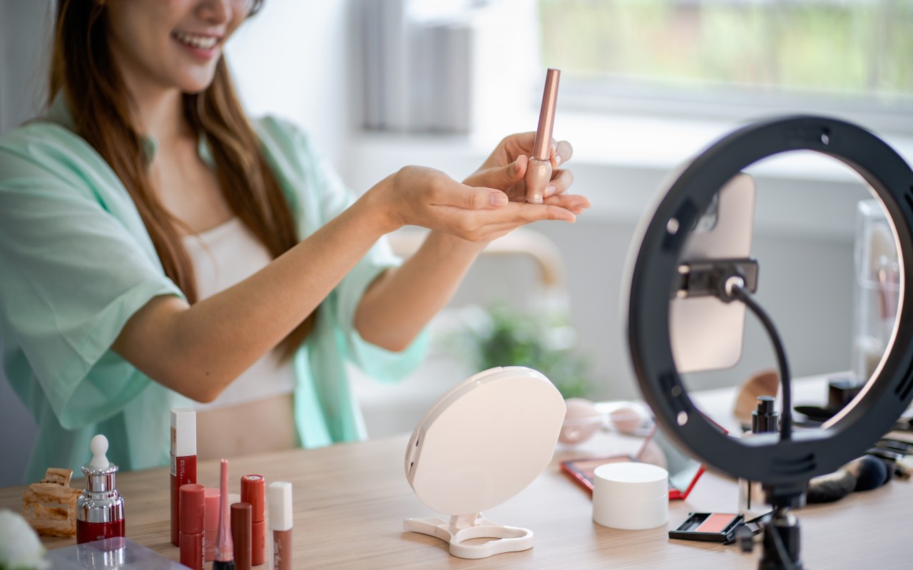 A girl recording a makeup tutorial.