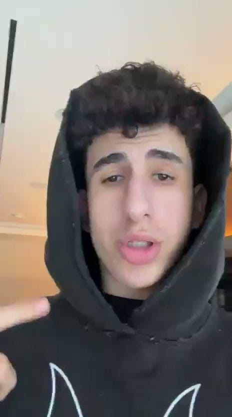 A man works on a laptop in an office.