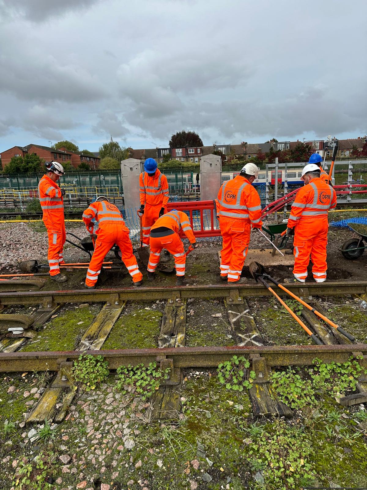 Entrance of a modern glass building with illuminated facade and reflections
