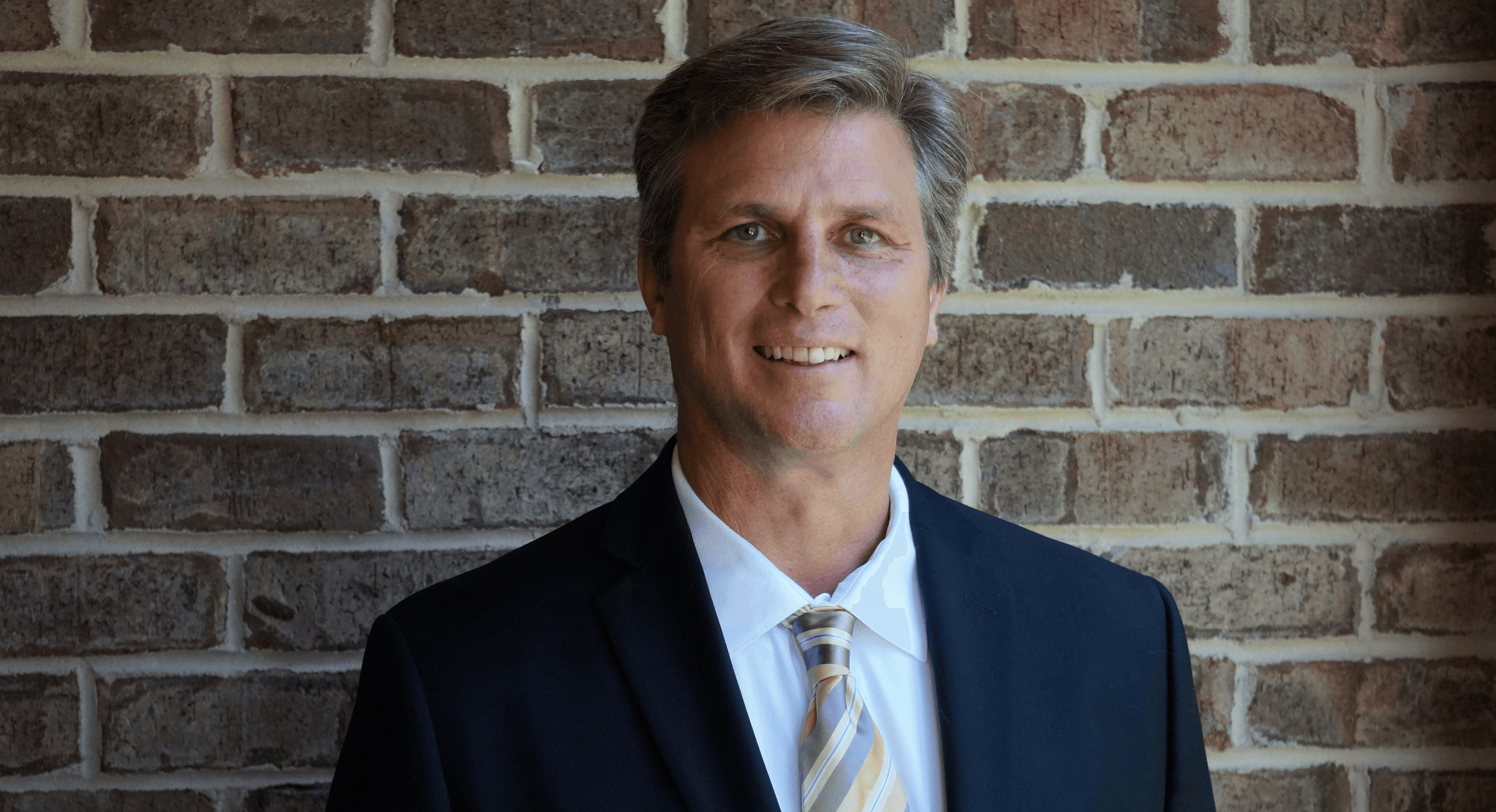 portrait photography of man wearing black suit jacket
