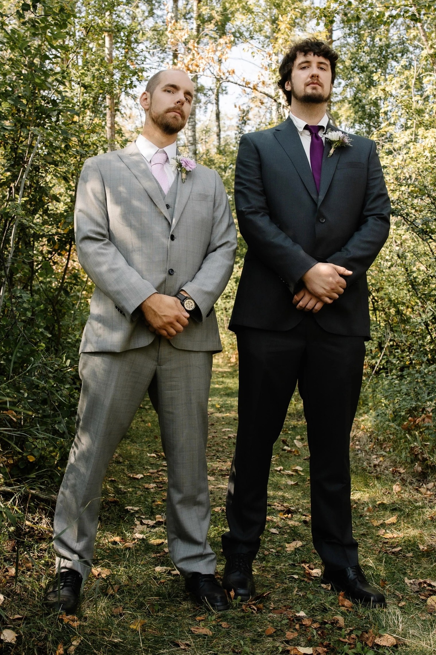 A bride in a lace wedding dress gently holds.