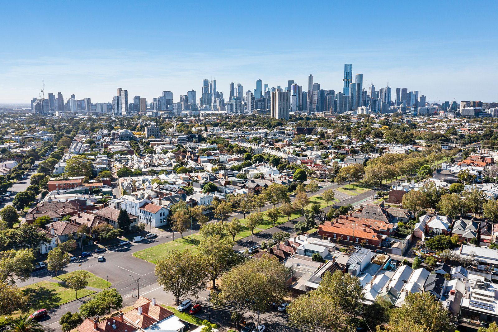 Aerial view of industrial park with buildings and parked cars.