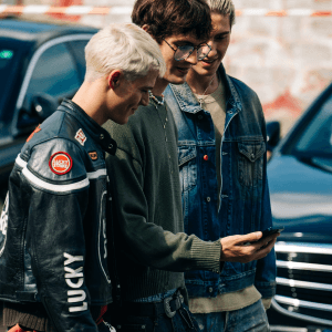 Group of fashionable men looking at phone