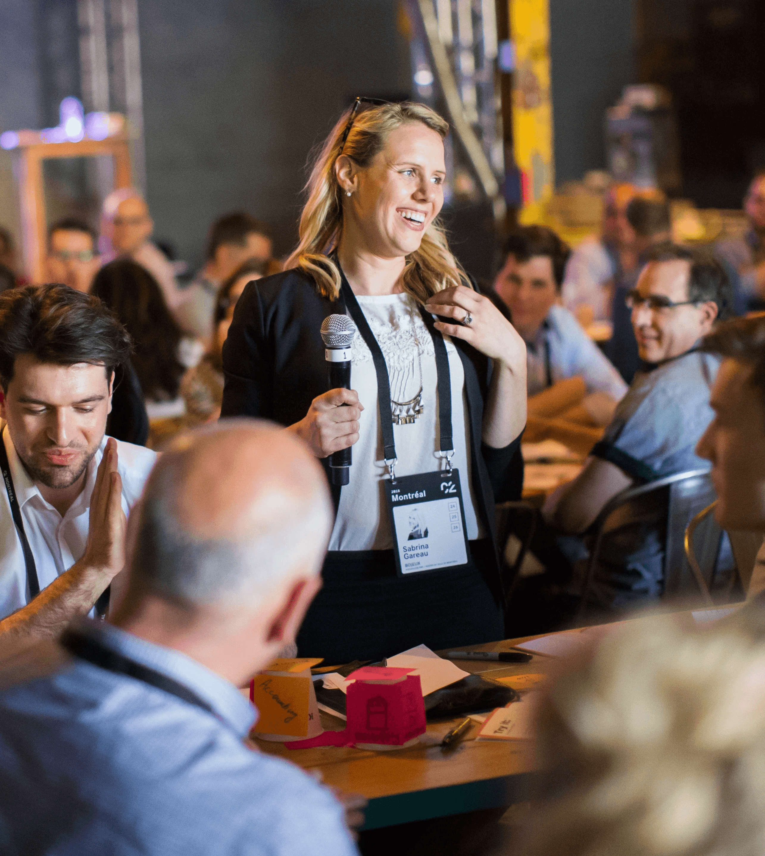 Speaker engaging with participants during a collaborative workshop at a C2 event, fostering dialogue and creative exchange.