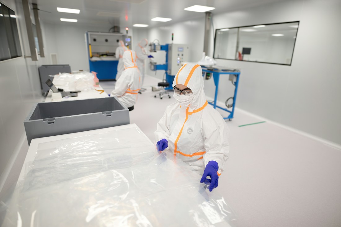 Gowned operators working in a controlled production area