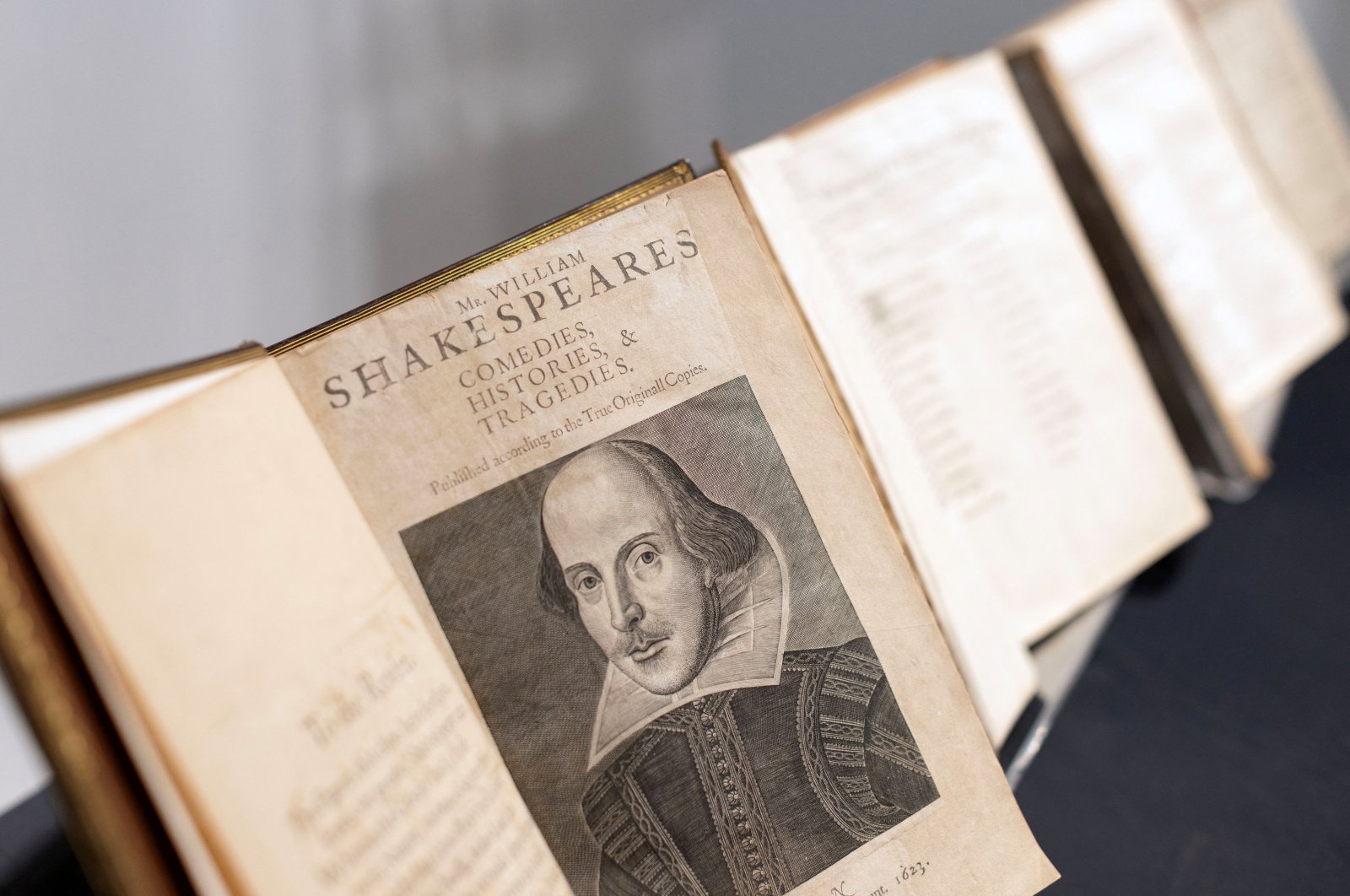 Open volume of Shakespeare’s collected works with his portrait