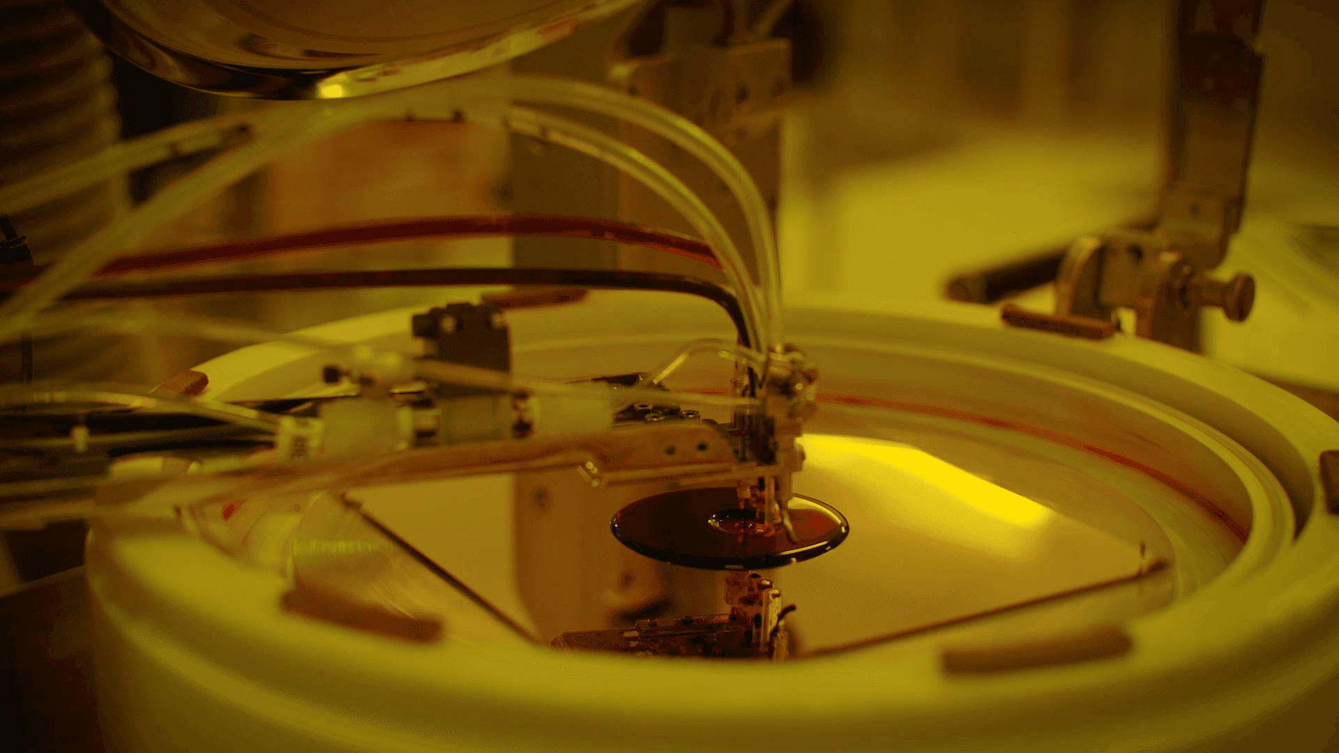 Ink being applied to a shiny piece of metal by a machine. 