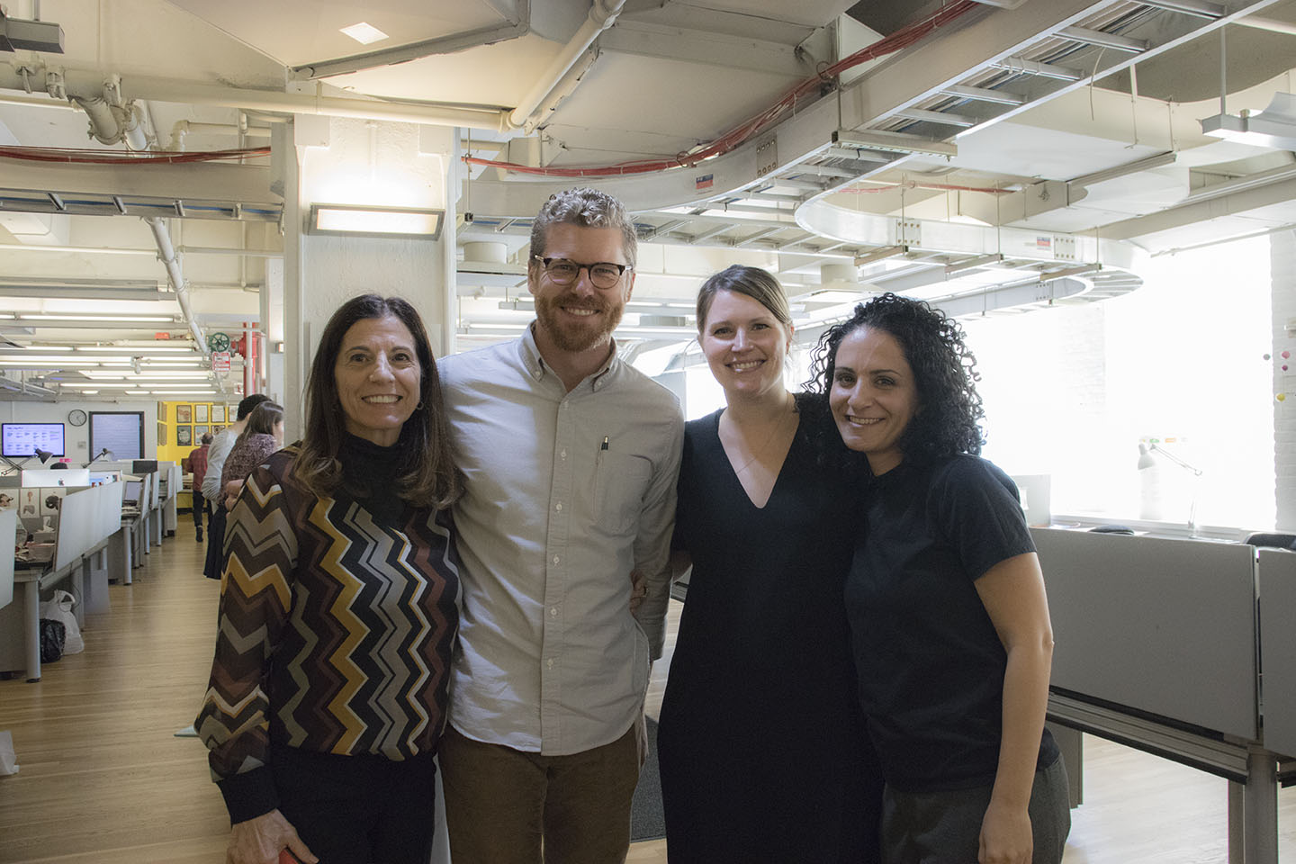 four people pose for a picture