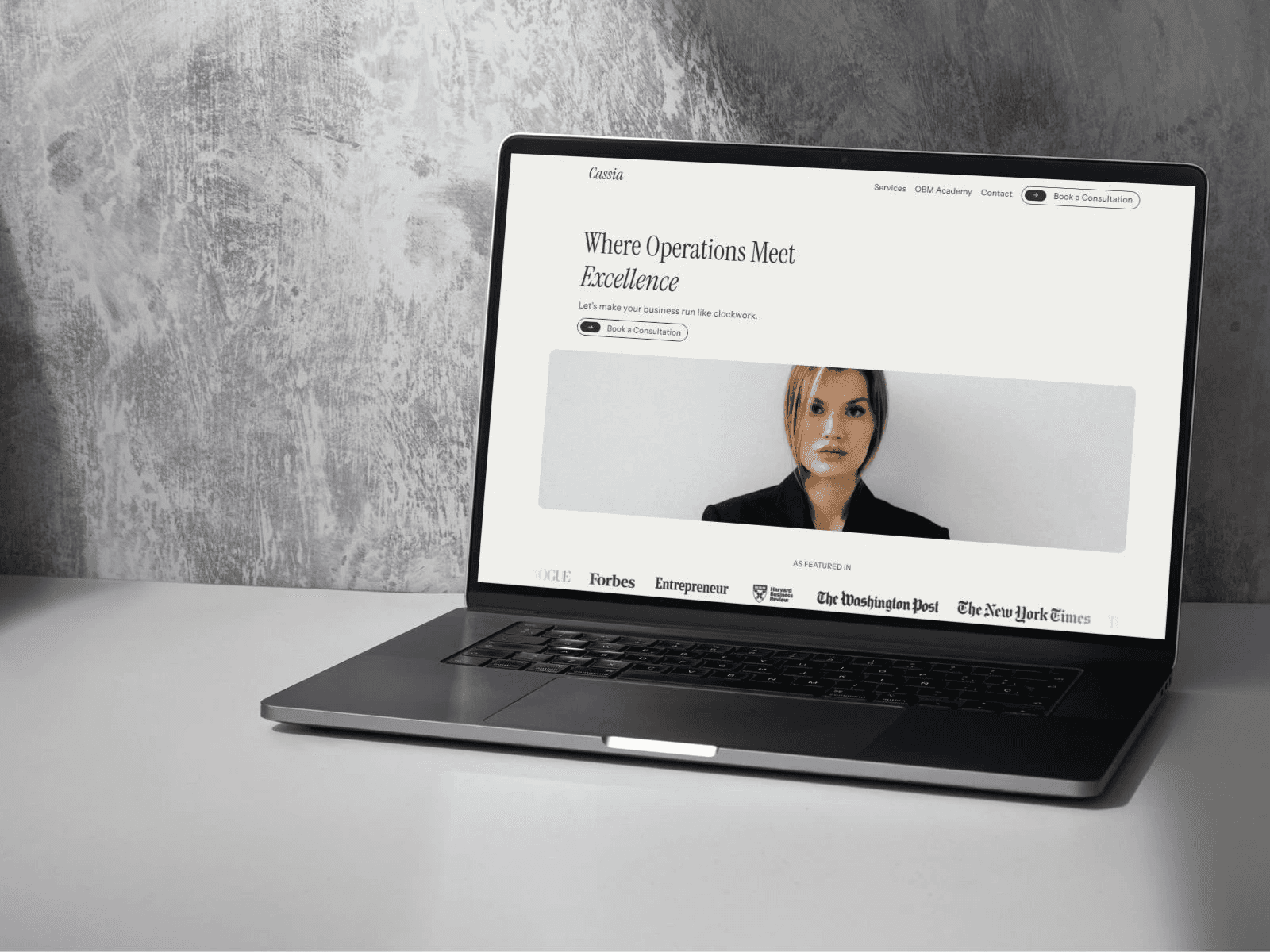 Open Macbook displaying Cassia's Framer template for OBMs