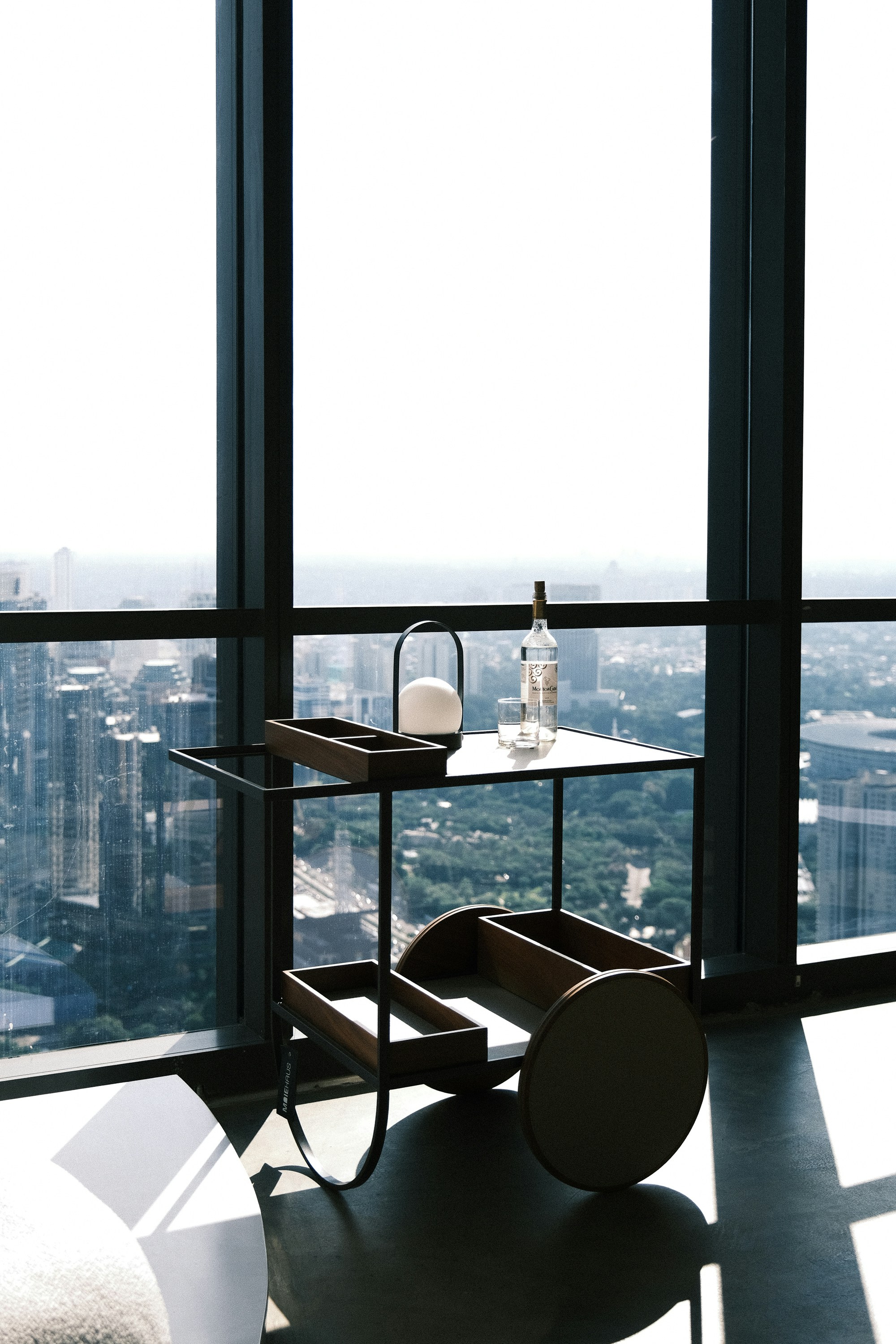 A chic bar cart with a city view.