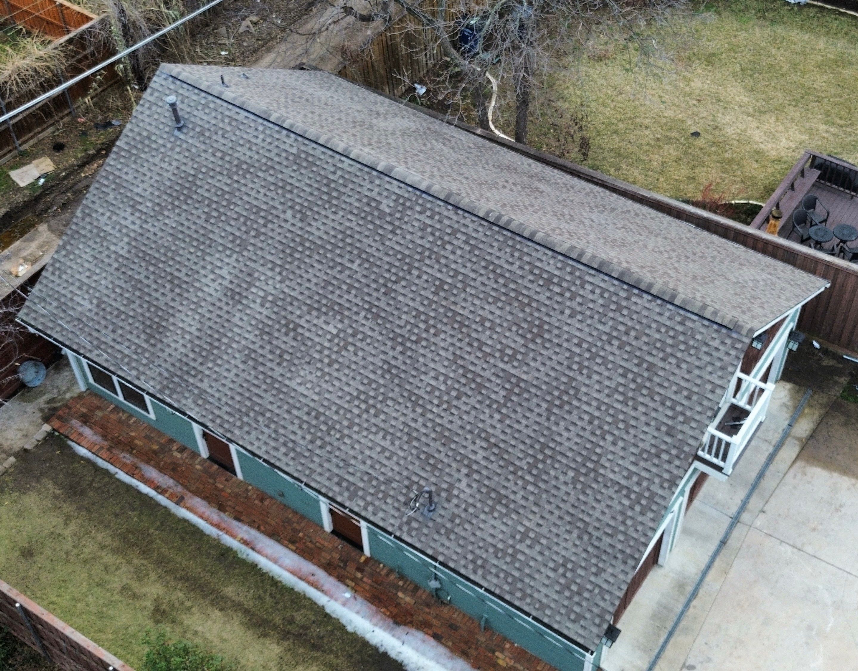 Side elevation showing the long roof plane and ridge line of the Winnetka Heights craftsman after the re-roof