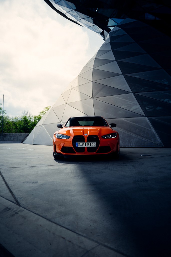 Orange BMW M3 G80 parked