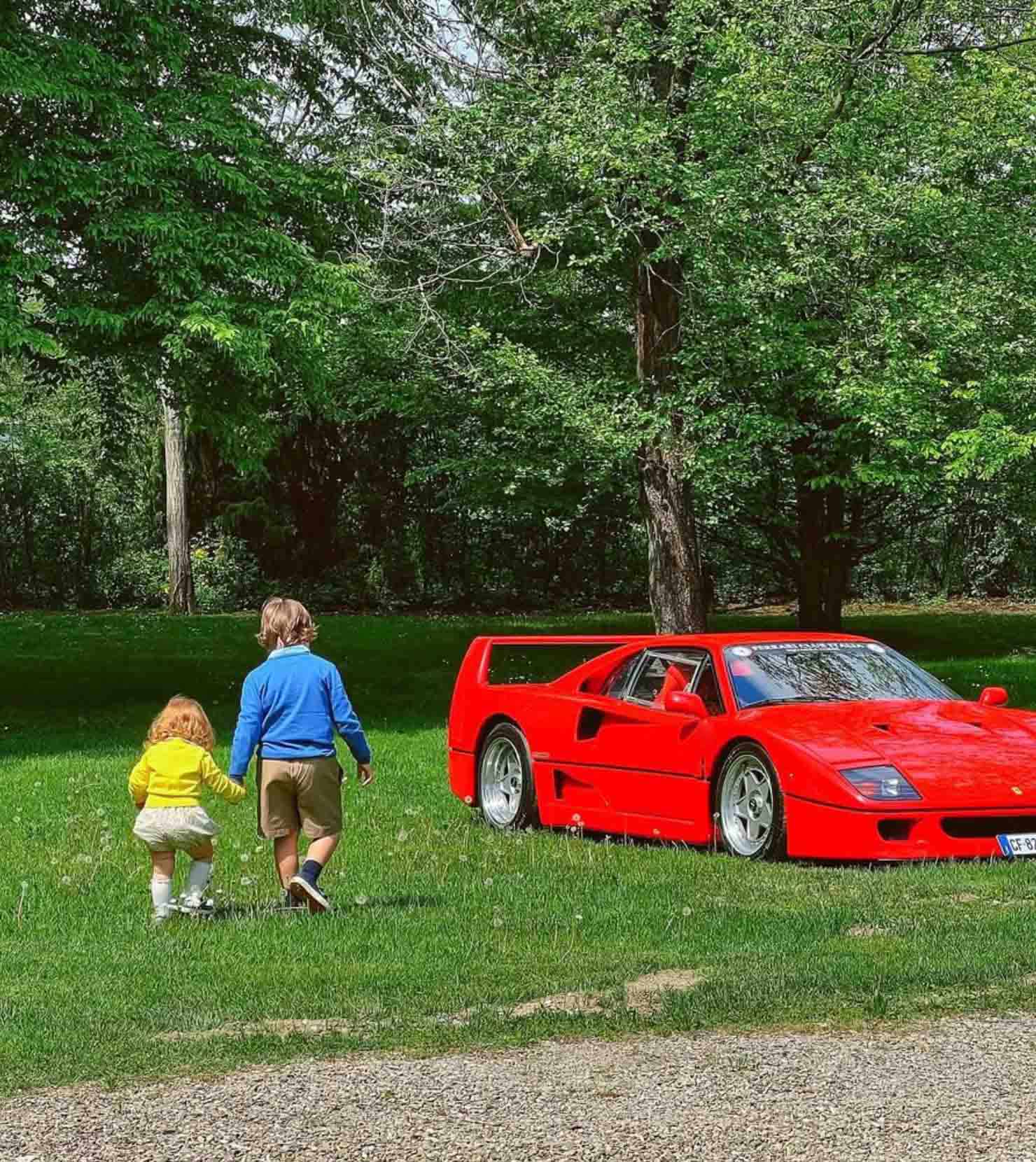 Childs with a red supercar