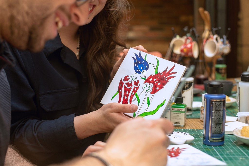 Two participants engaging in Turkish tile painting at a ceramic workshop in Istanbul. Experience one of Istanbul's most unique attractions by learning traditional Turkish tile art.