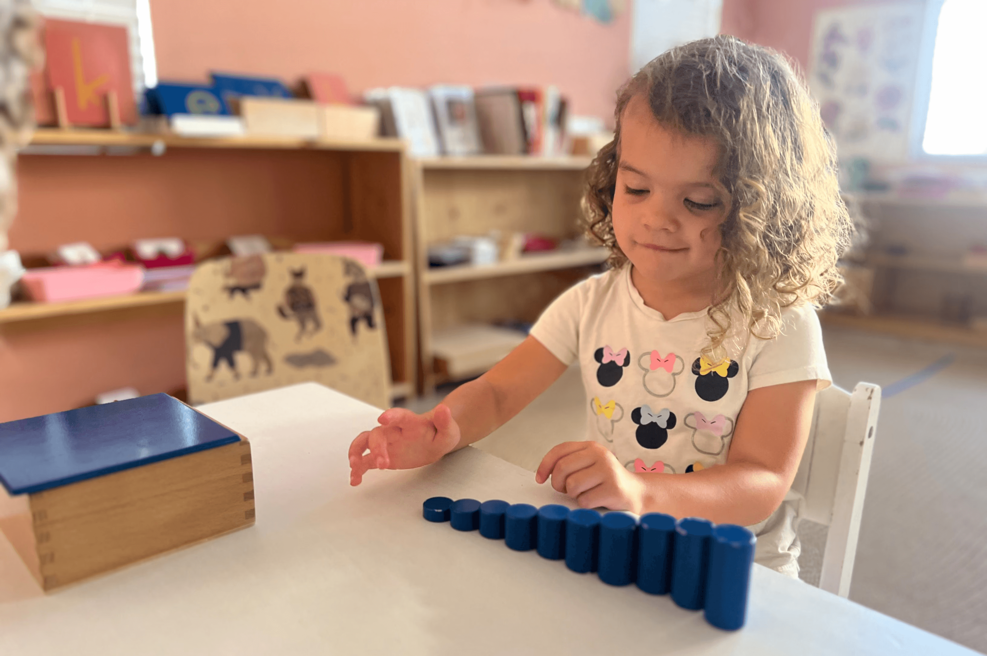 Child working with Montessori materials in a prepared classroom environment at Little Explorers Montessori in Irvine
