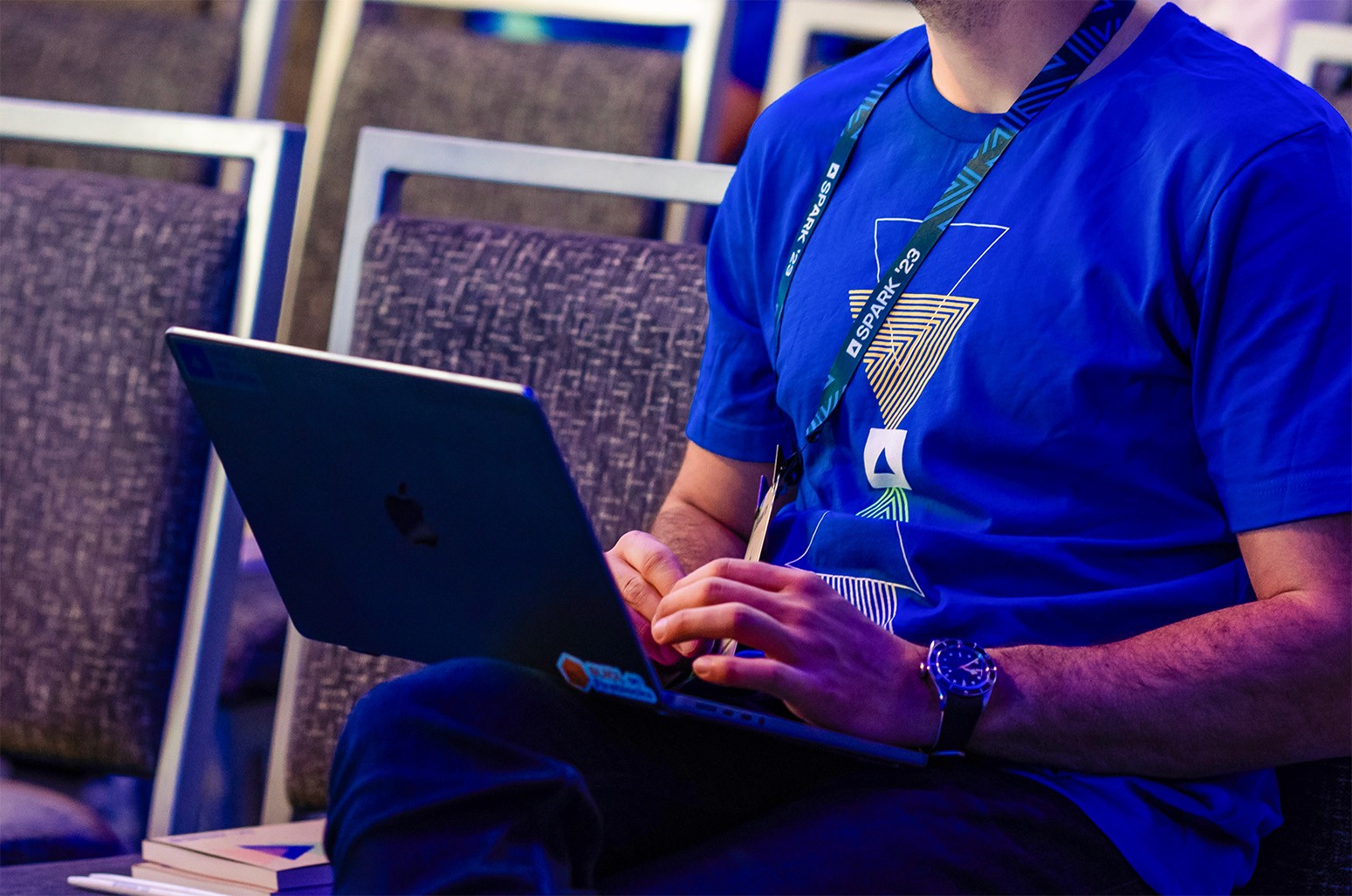 Photo of a man wearing a SPARk t-shirt and the SPARK lanyard.