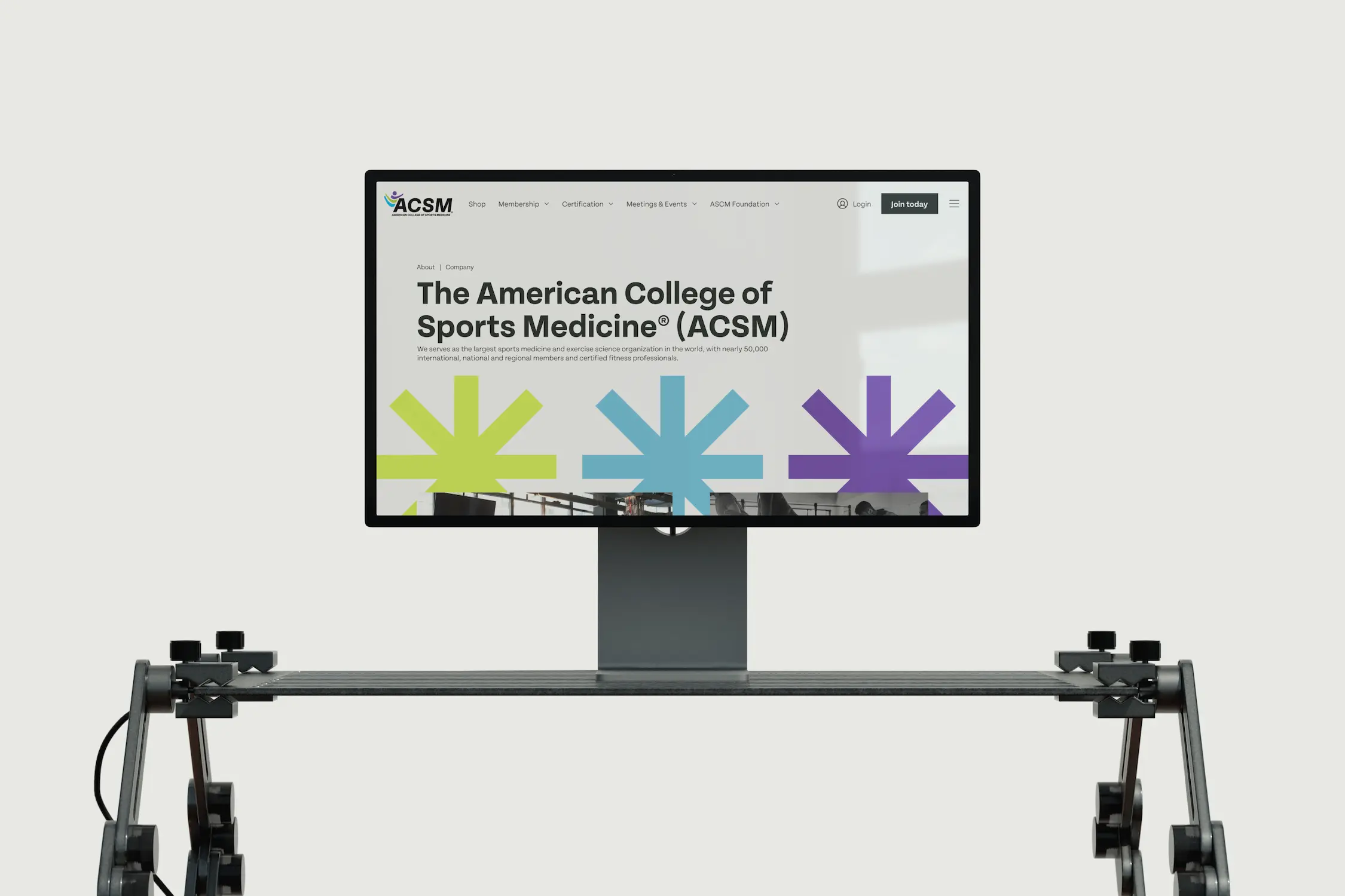 A digital screen displaying colorful splashes, mounted on a flexible stand with cables on either side.