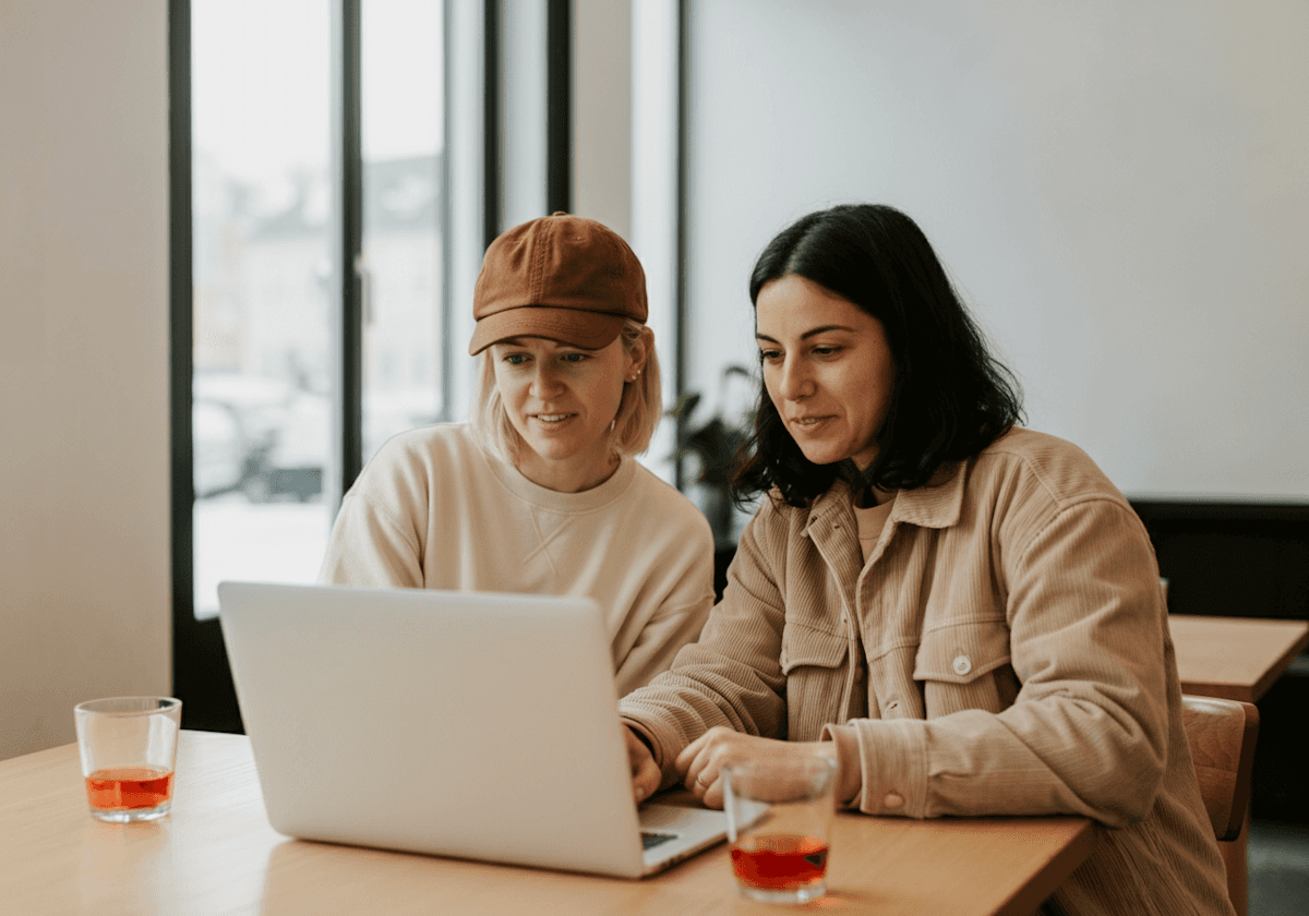 Two designers working together on a laptop
