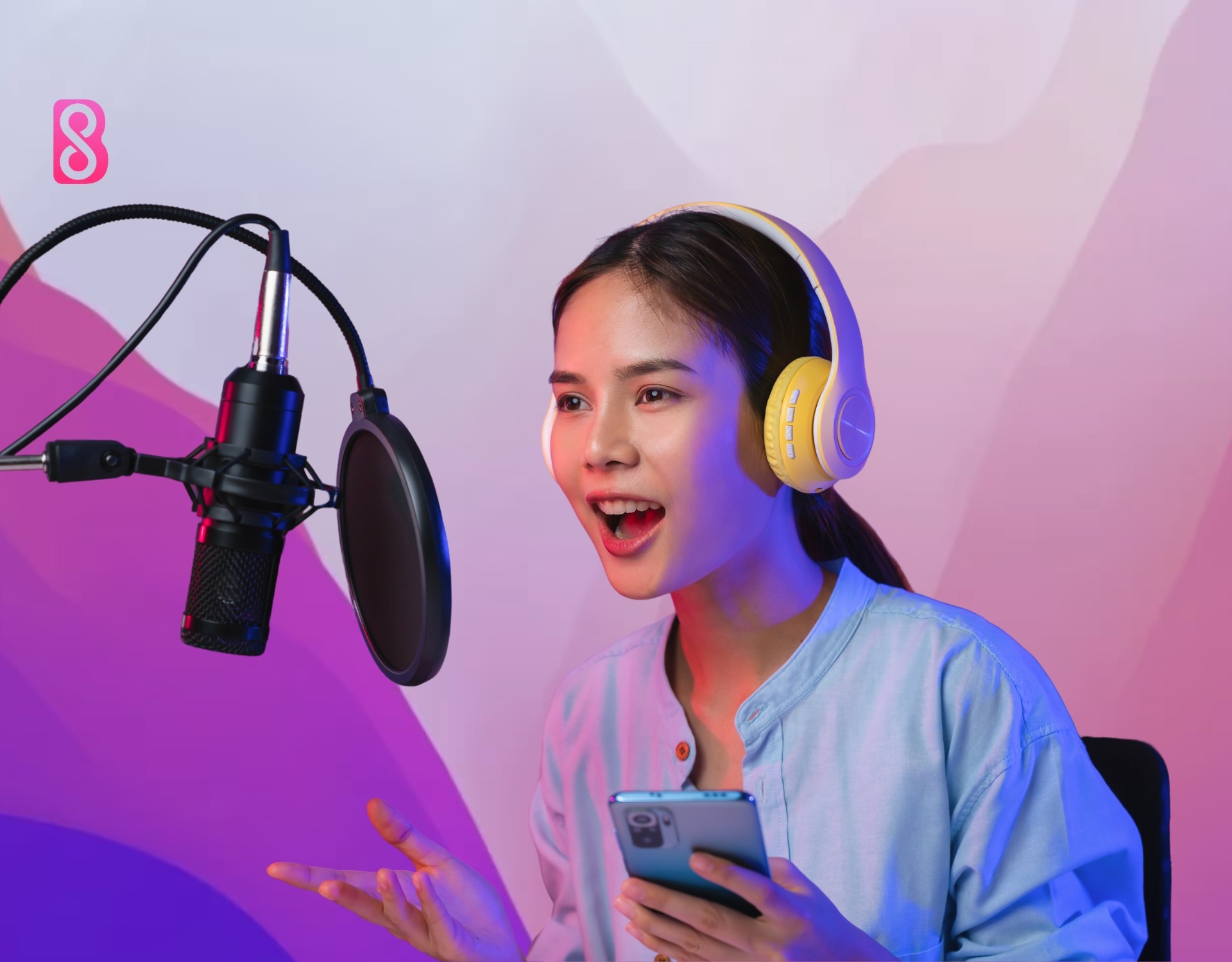 A girl recording a podcast at her studio