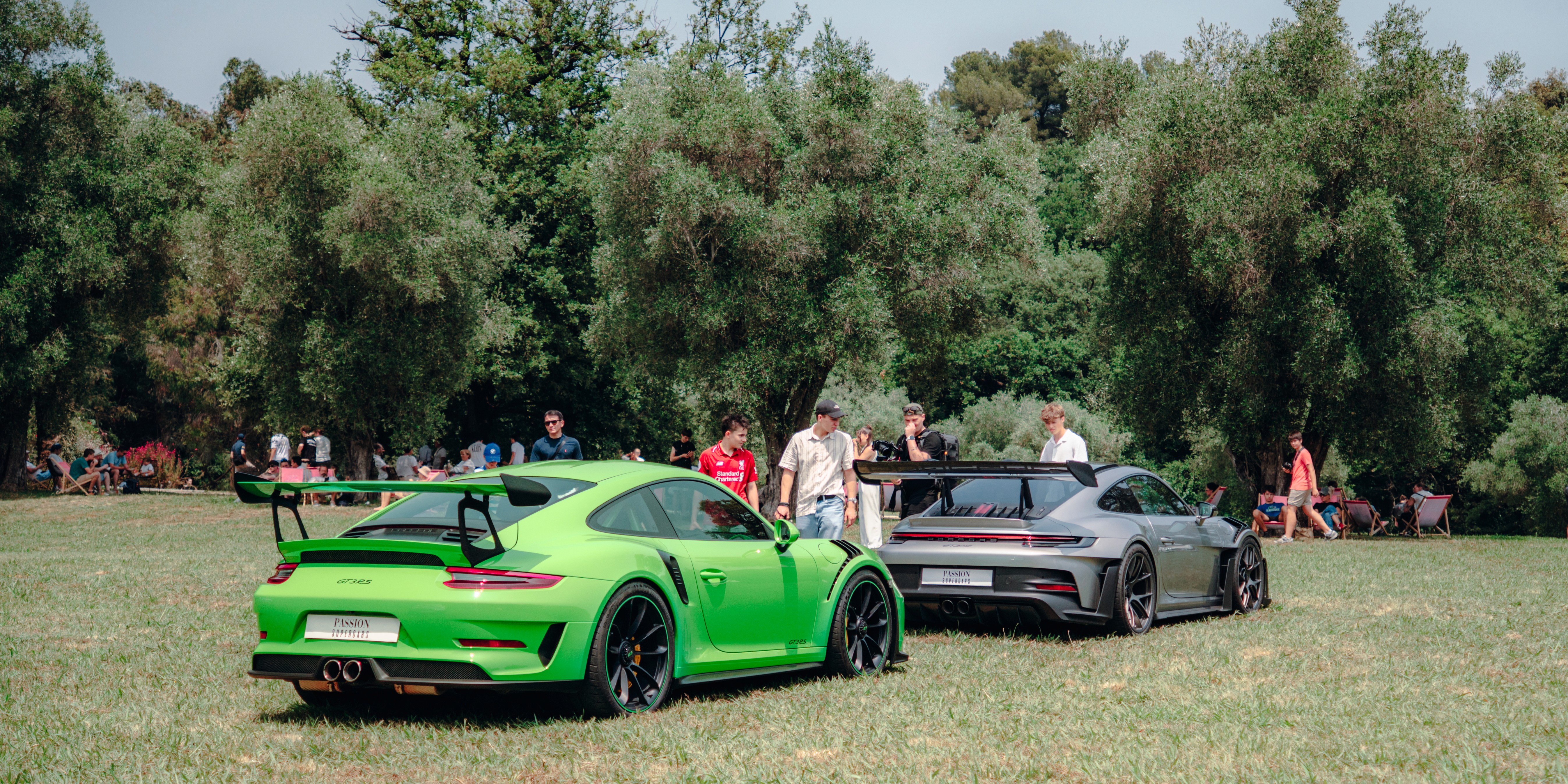 Man in suit receiving an award on stage during a business conference, with another man and a woman in the background.