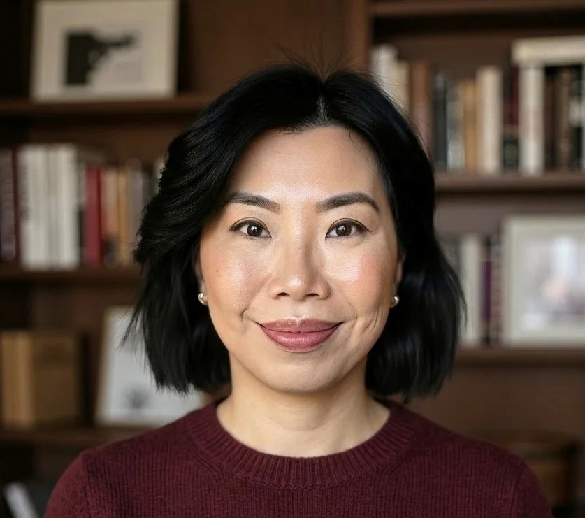 Woman with black hair and a burgundy sweater.