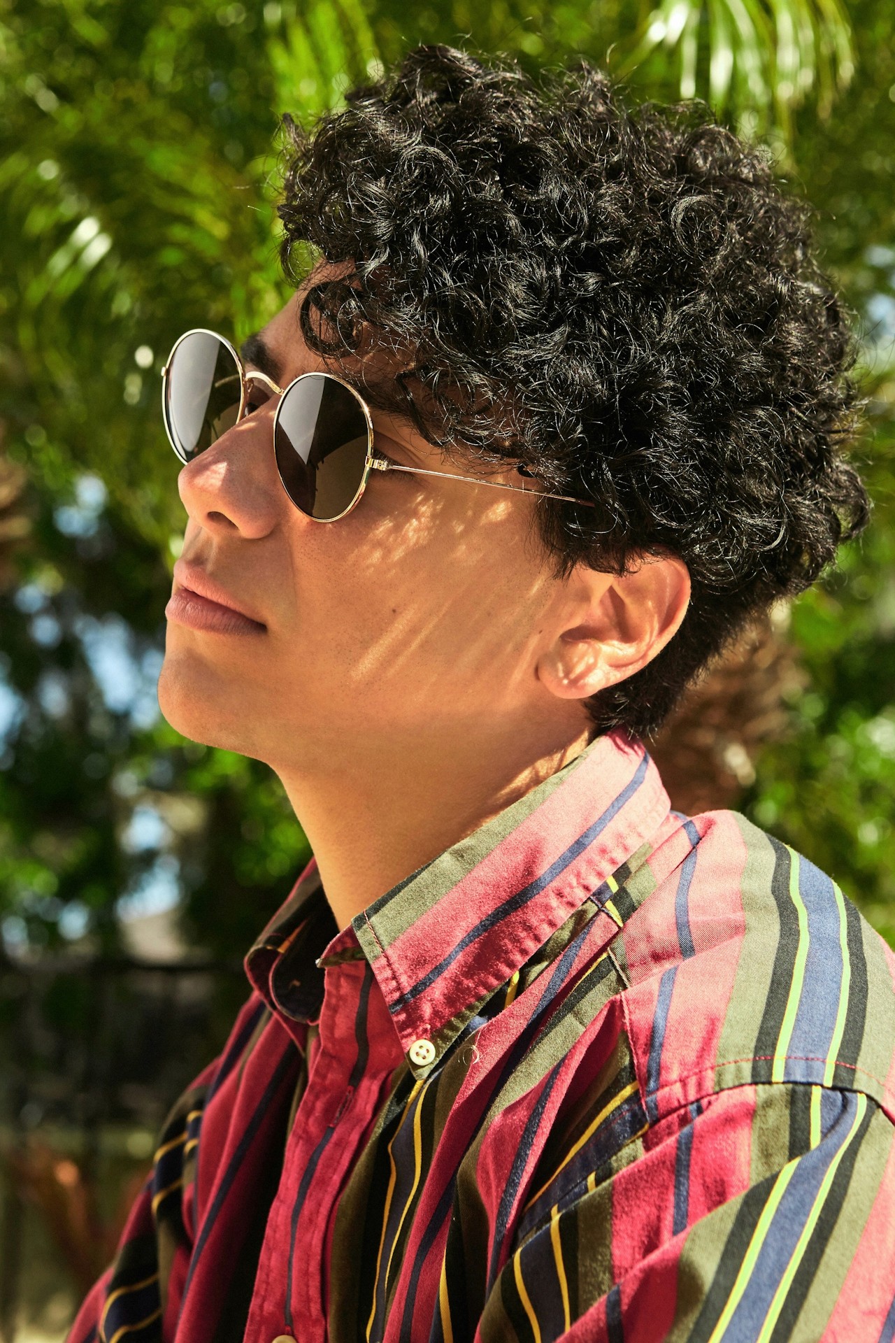 Portrait of a man wearing dark-rimmed or black-framed eyeglasses.