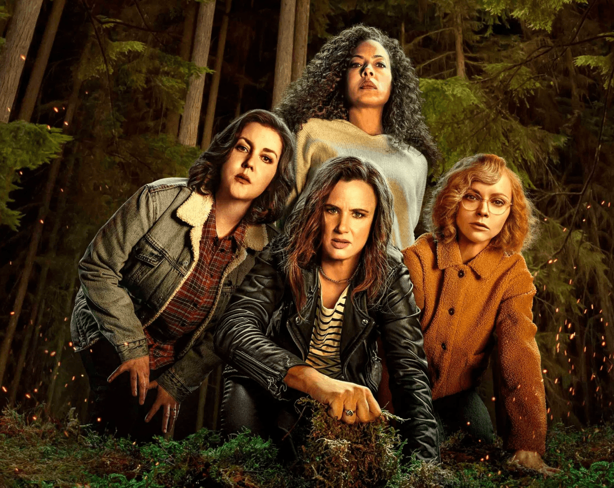A close-up of a pink cocktail in a martini glass, set against a nighttime background with soft, blurred colors.