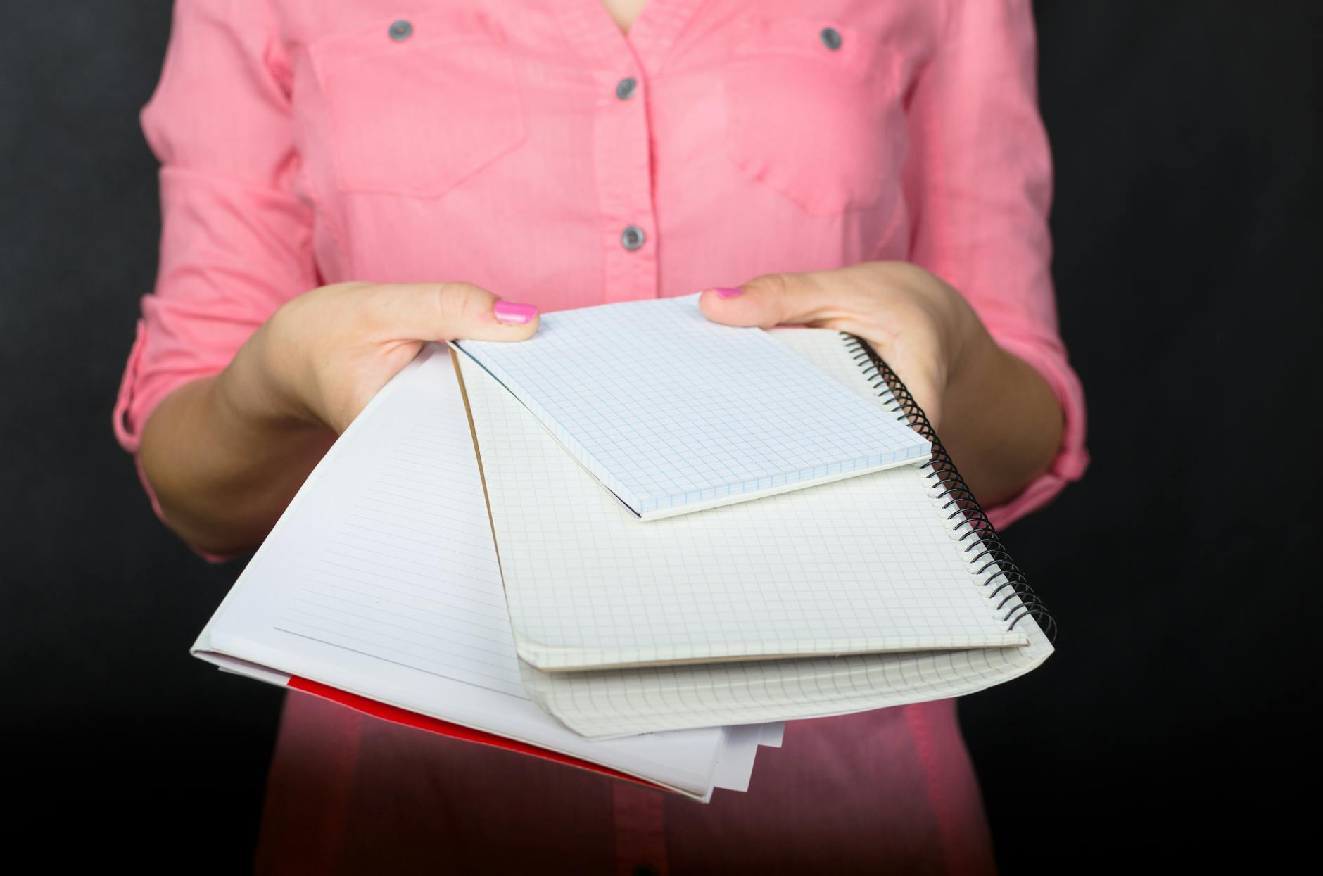 Teacher writing a list of student-led community agreements on a large whiteboard in a bright, modern classroom.