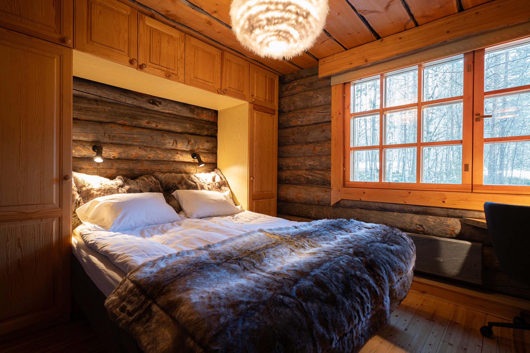 person sitting on grass and using phone