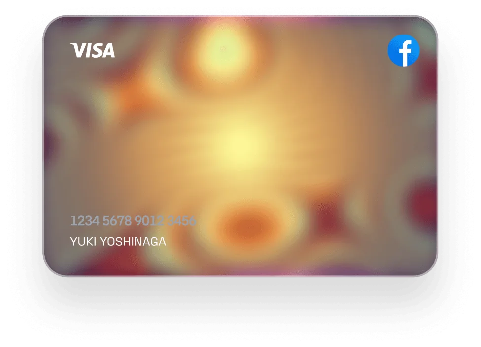 Visa credit card with warm gradient background, cardholder name Yuki Yoshinaga, and Facebook logo in top right corner.