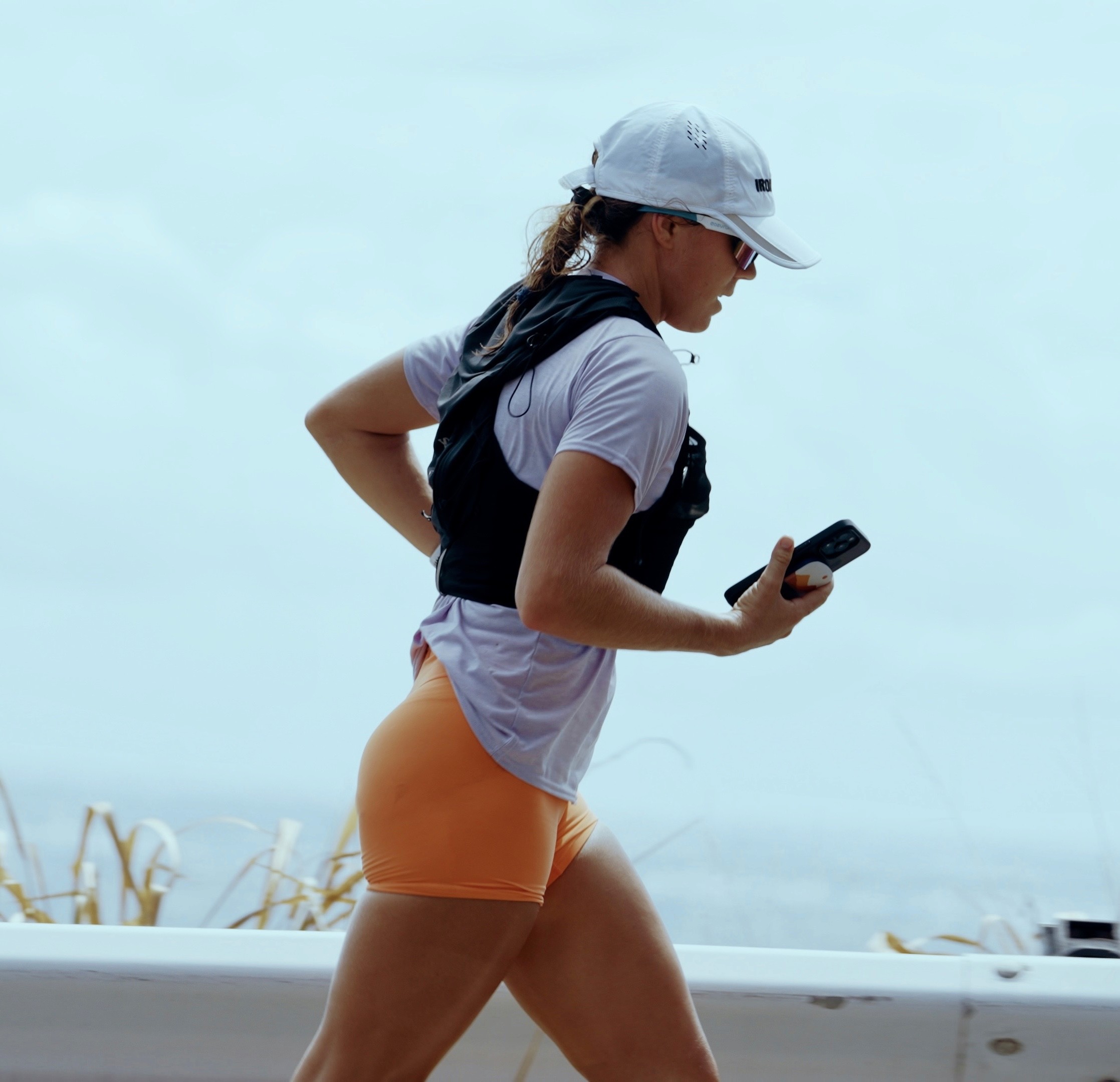 Rachel, personal trainer, looking to the side confidently in a fitness studio