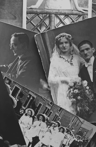 A person with curly hair sits at a desk, working on a laptop in a cozy, well-lit environment.