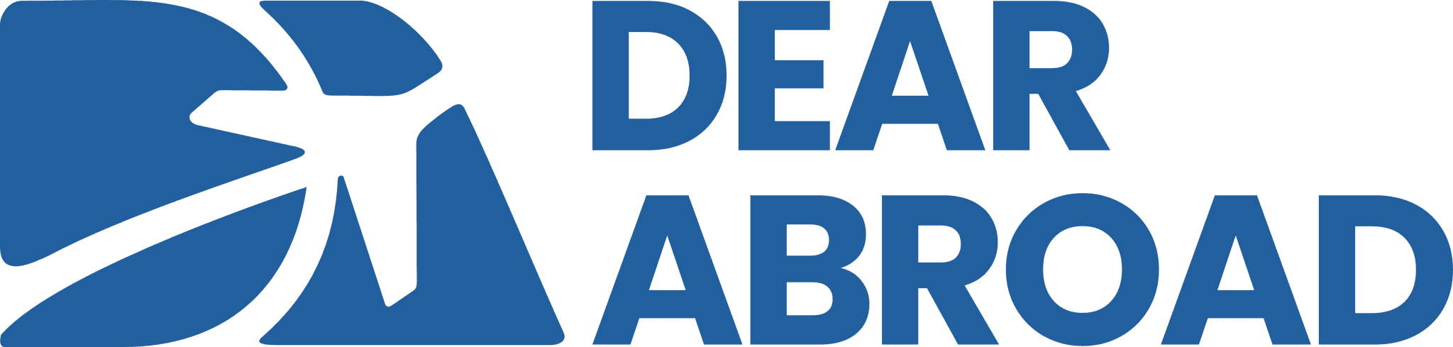 A young person with curly hair smiles at the camera while sitting in front of a laptop against a dark background.