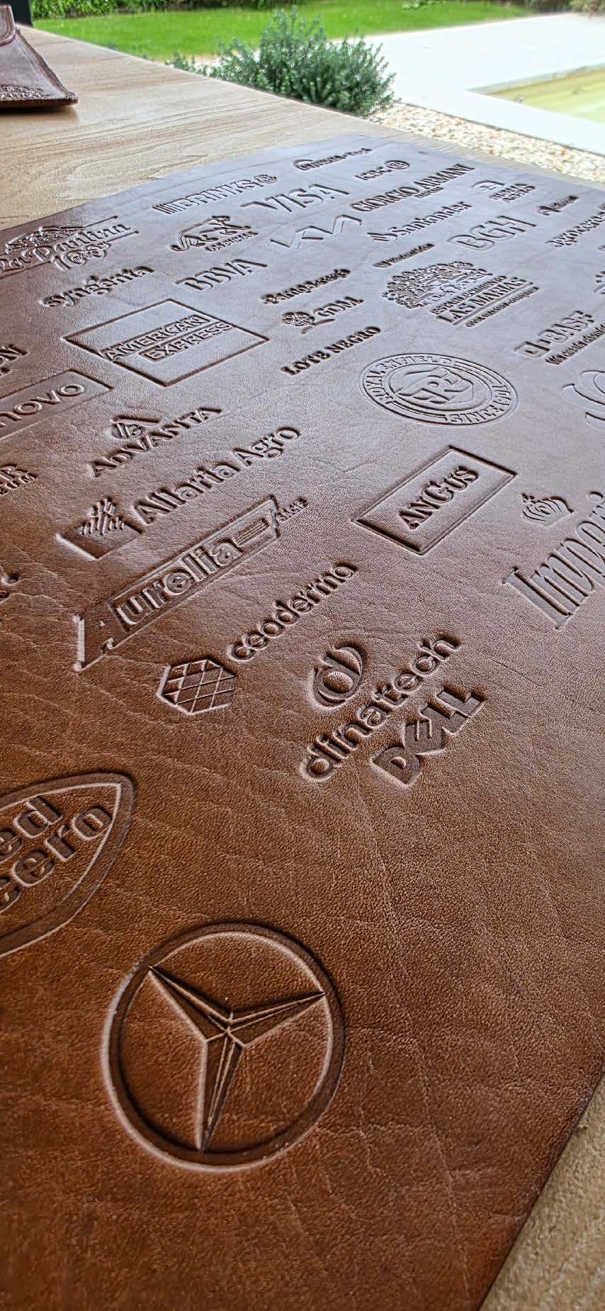 Aerial view of a winding road cutting through rocky terrain with patches of grass.