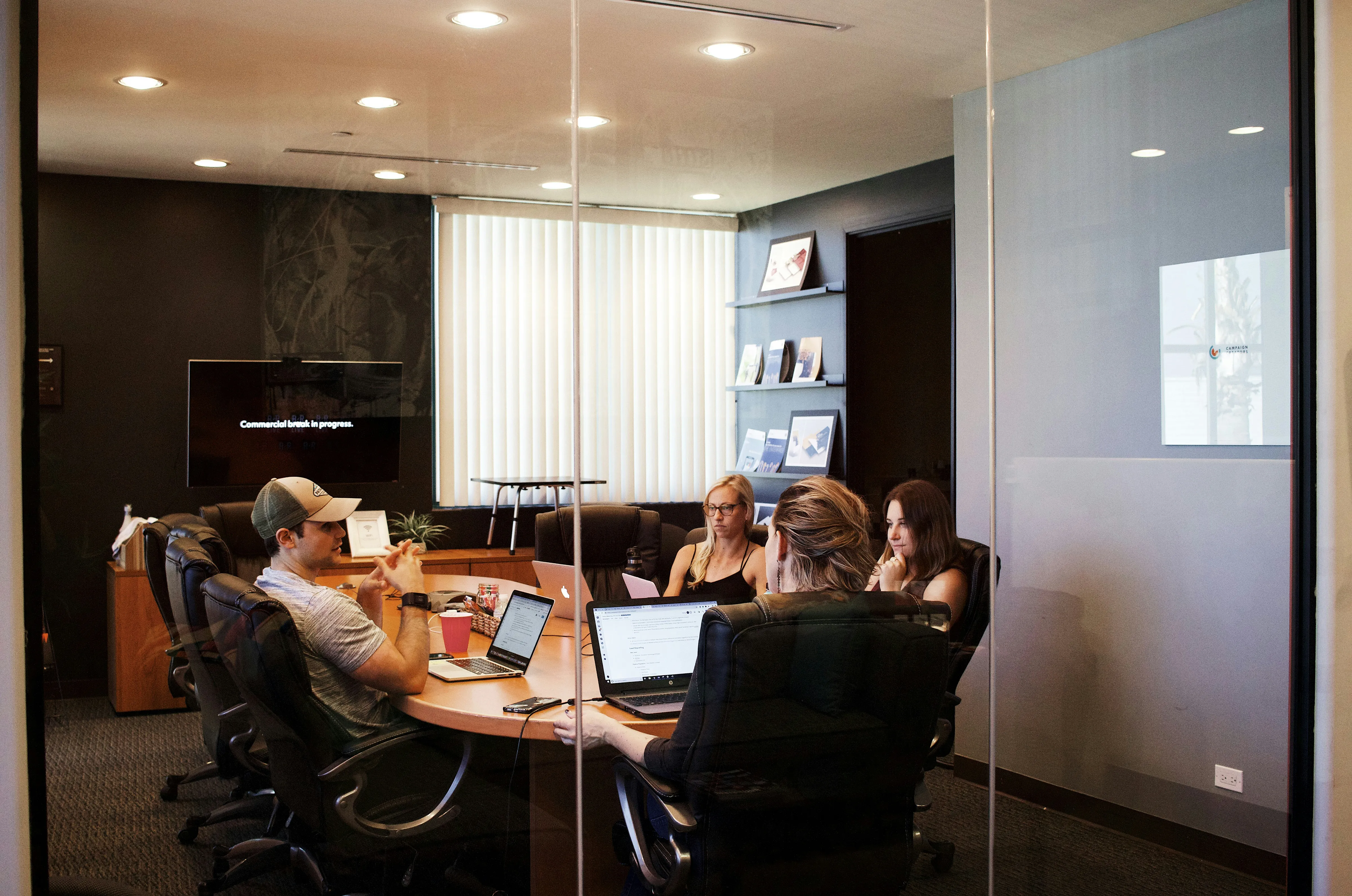 Business people sitting in a glass conference room