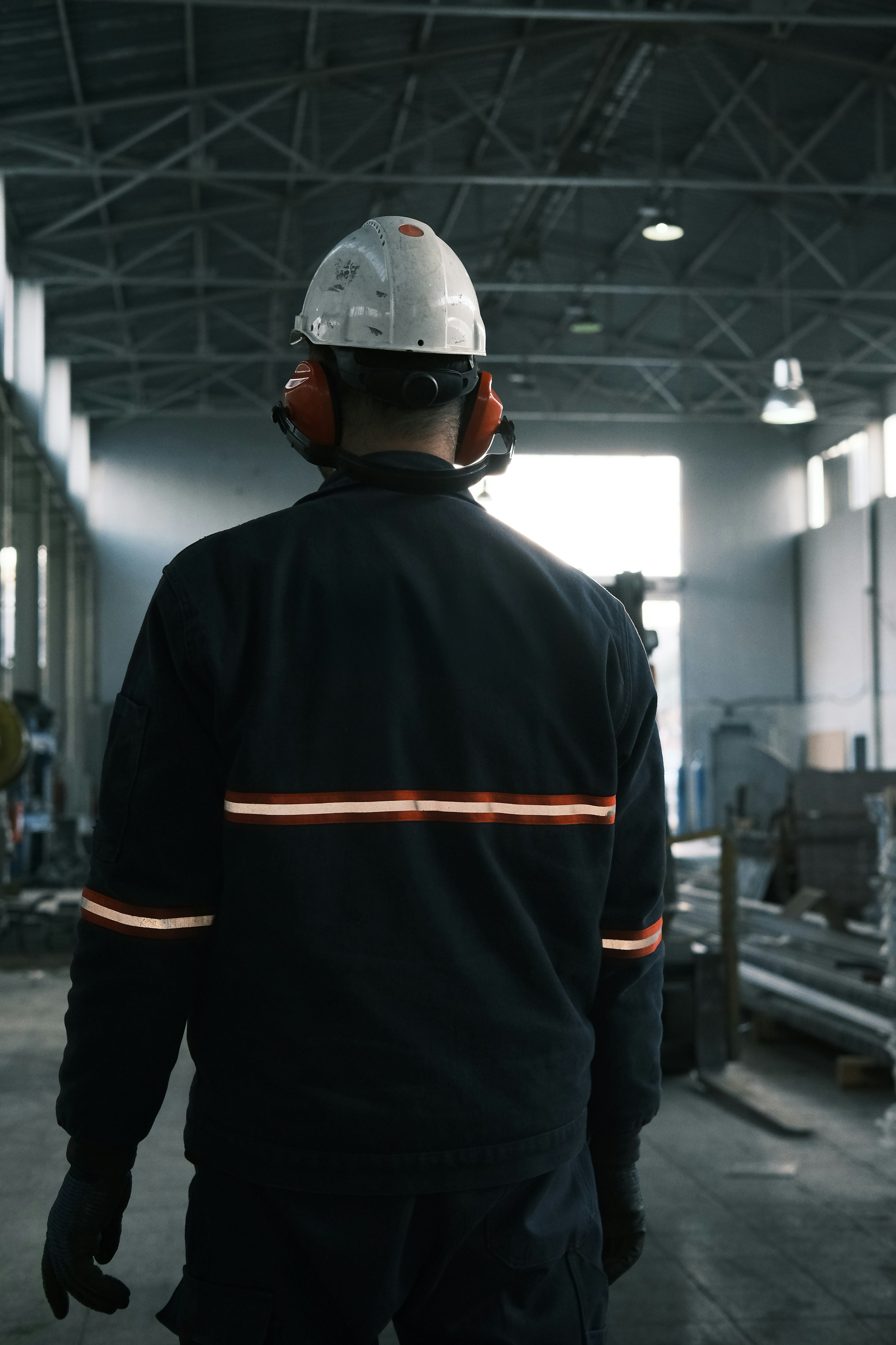 A man in a factory wearing a hard hat