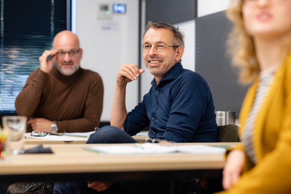 group of people listening to a seminar in a classroom