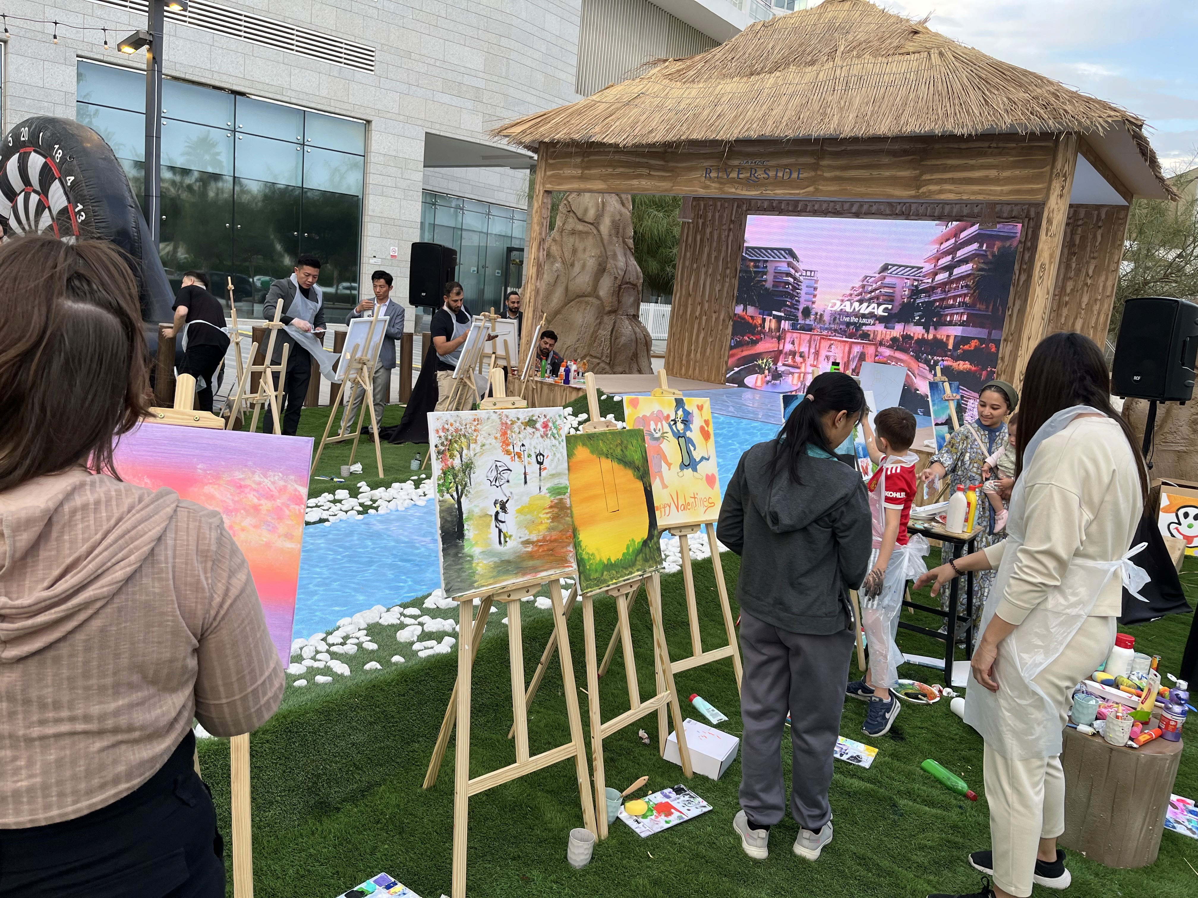 Guests interacting with painting interactive activation at a Dubai brand activation by an entertainment agency Dubai.
