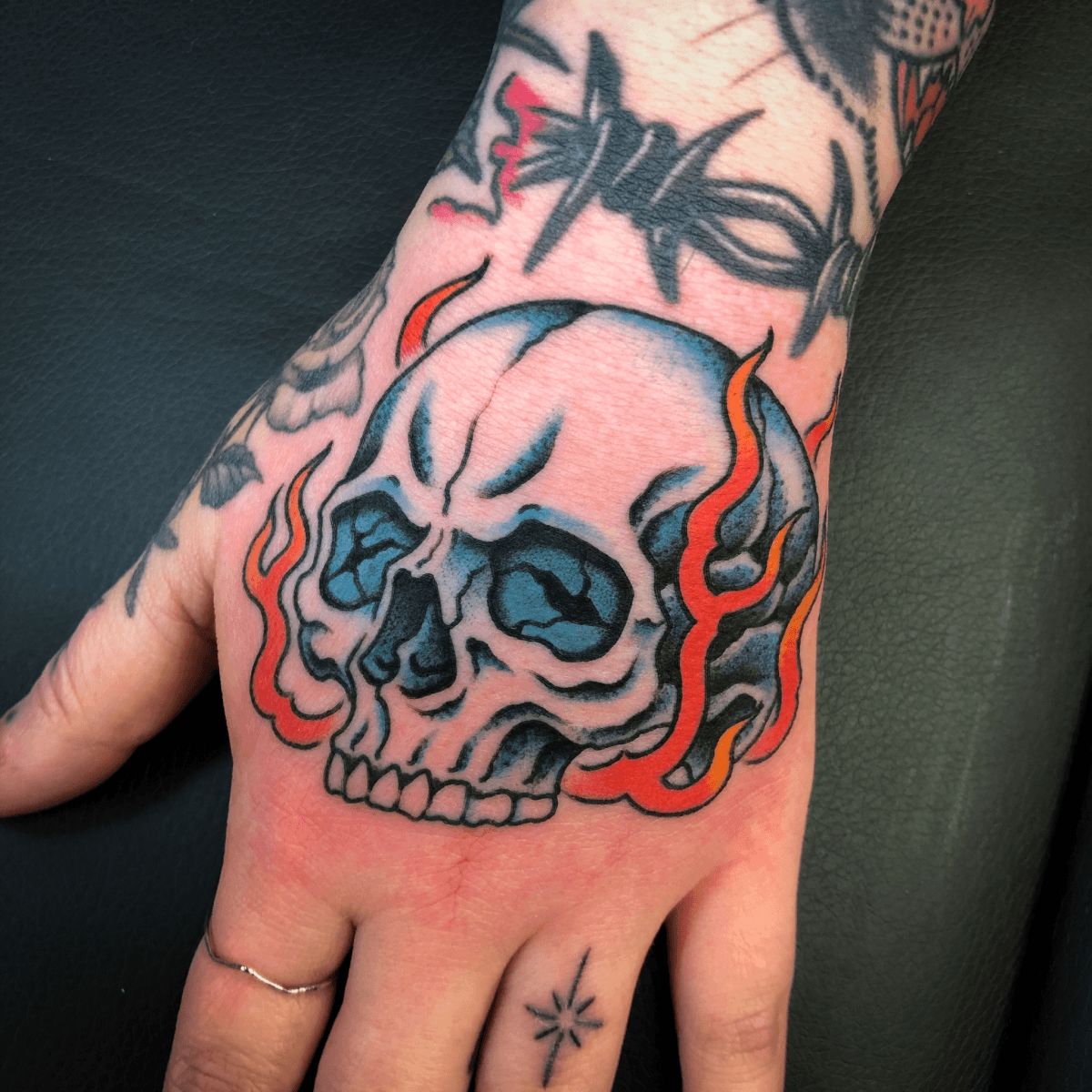 color tattoo of a skull on fire