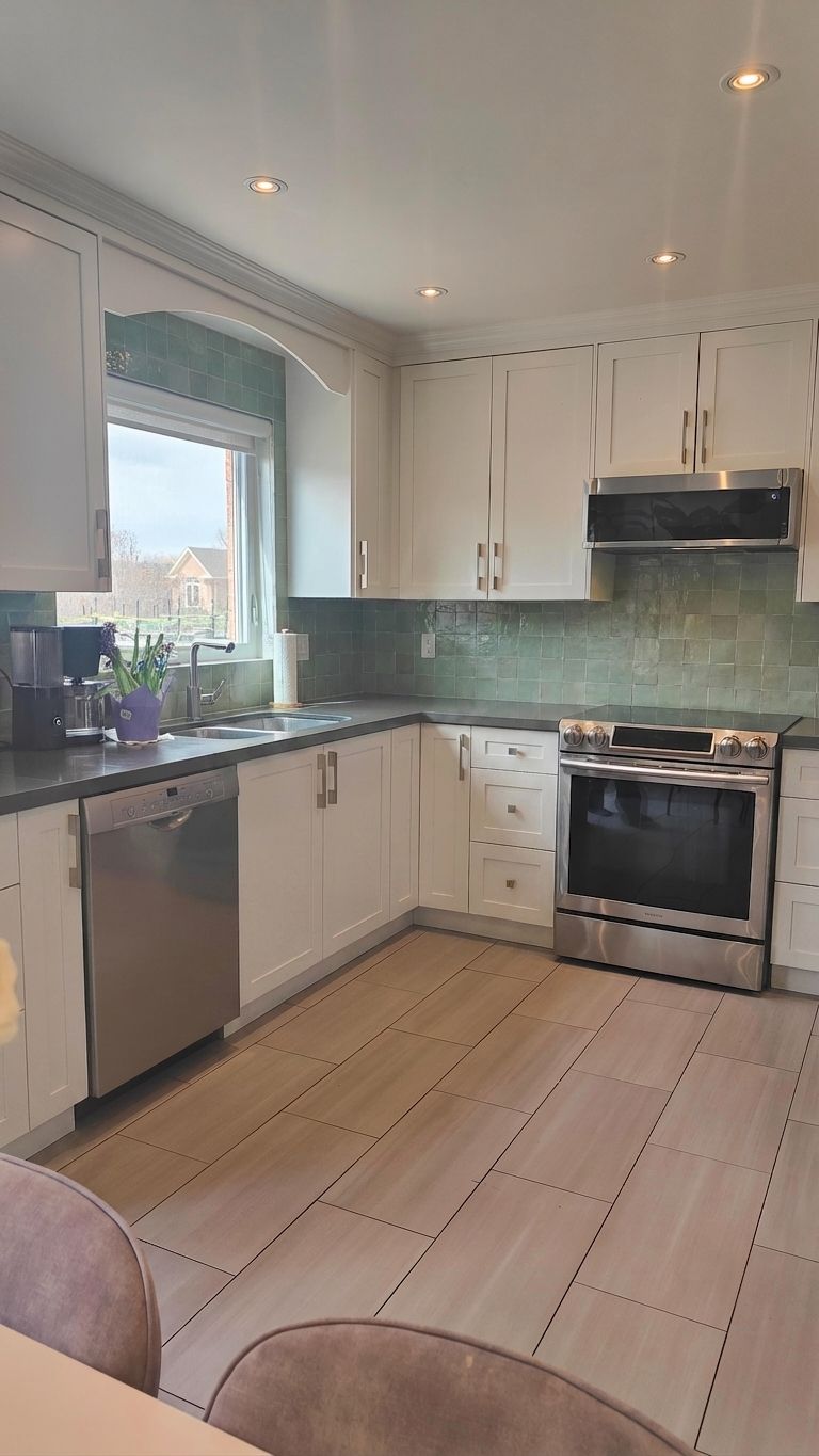 White painted lower cabinets with sage green zellige backsplash — the crowd-voted direction