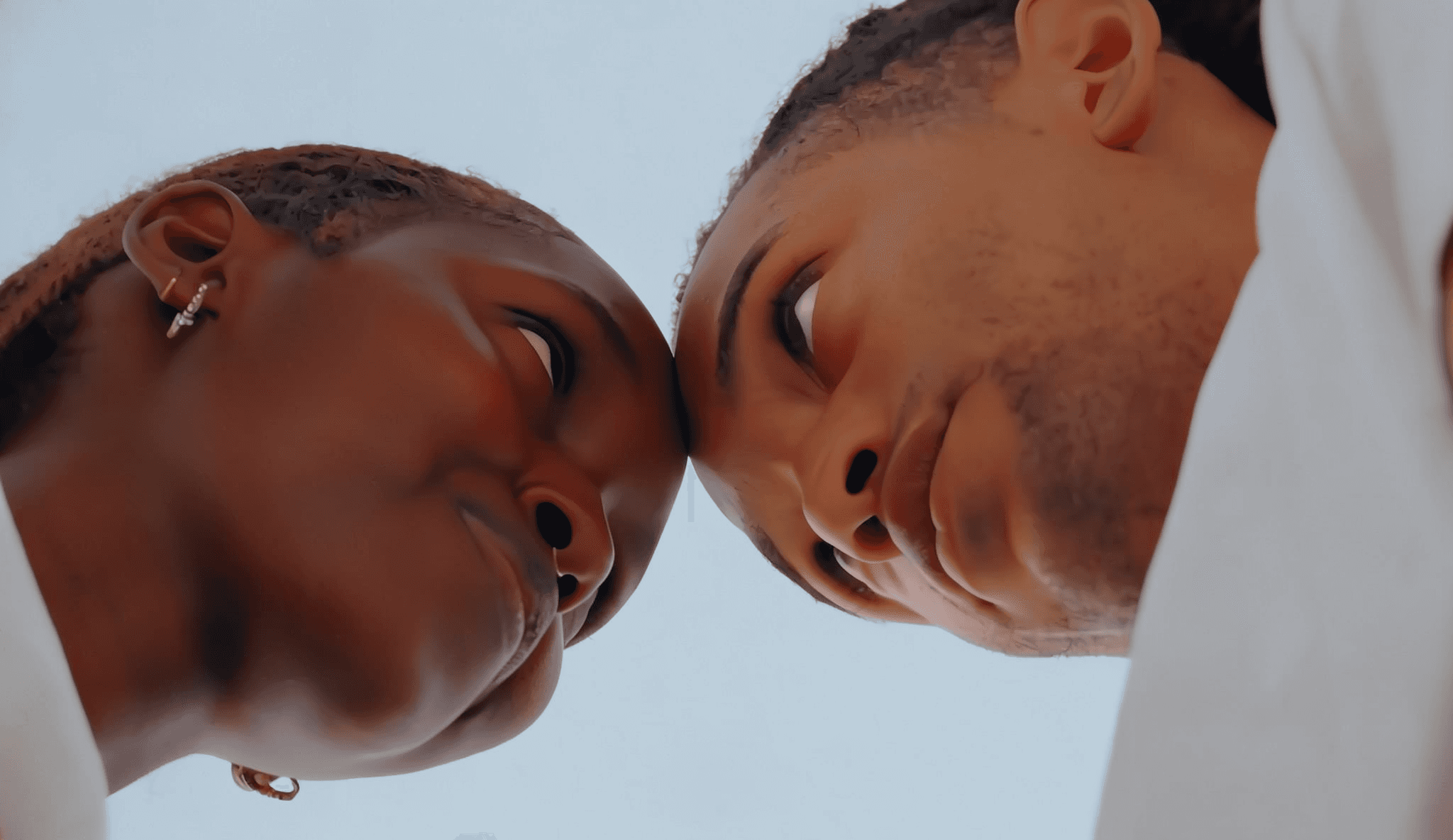 Two people facing each other gently, AI-generated.