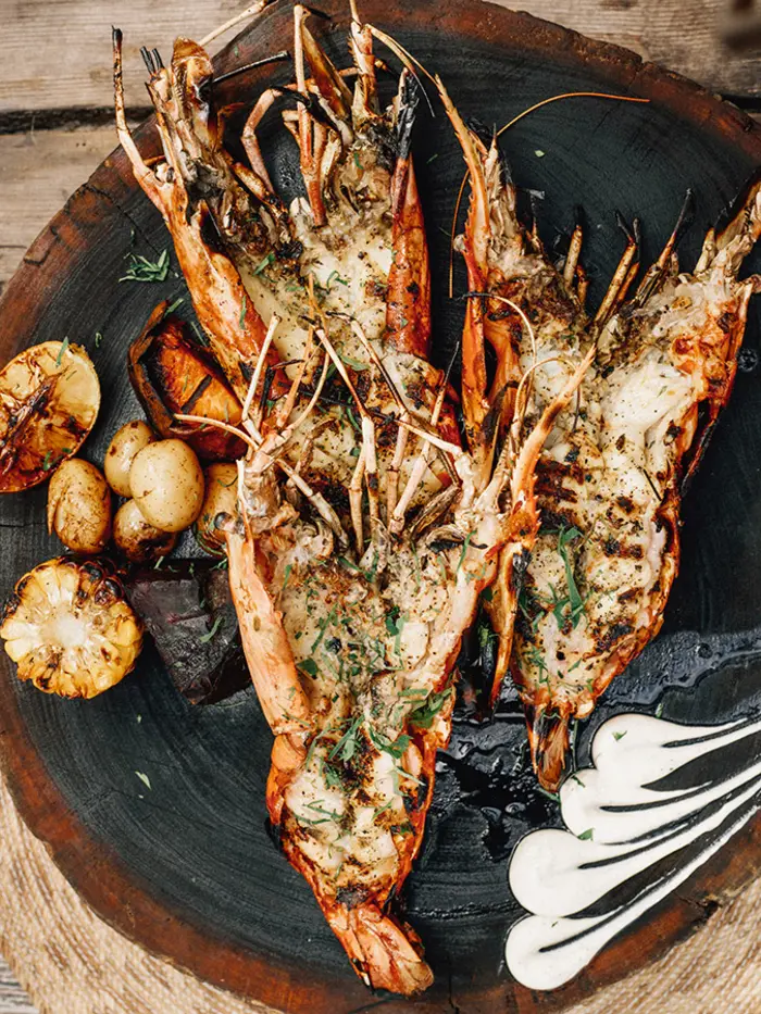 Lobster dish served with vegetables at La Popular restaurant in Nômade Tulum, Mexico.