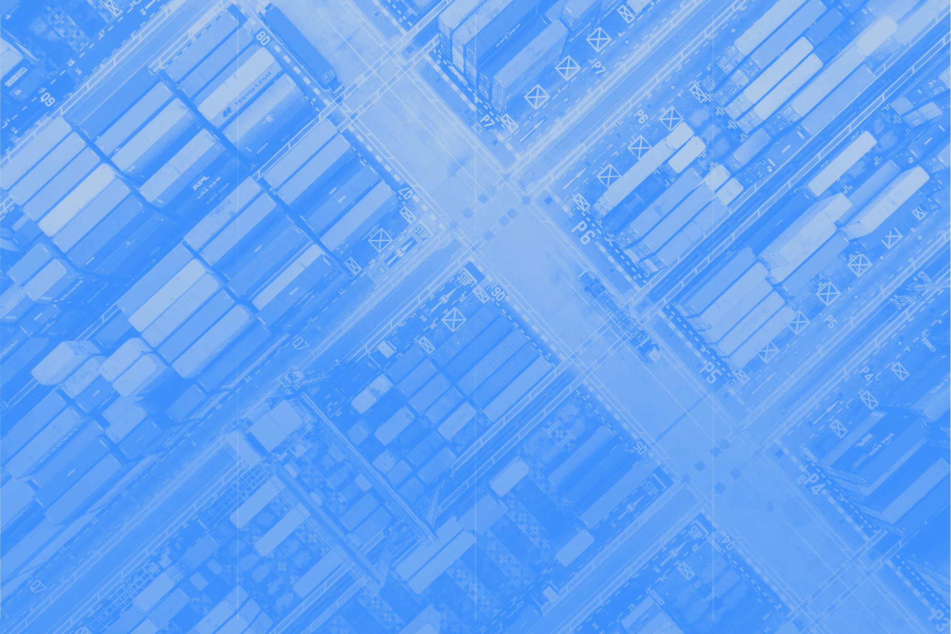 Distribution center surrounded by empty parking spaces and autumn trees